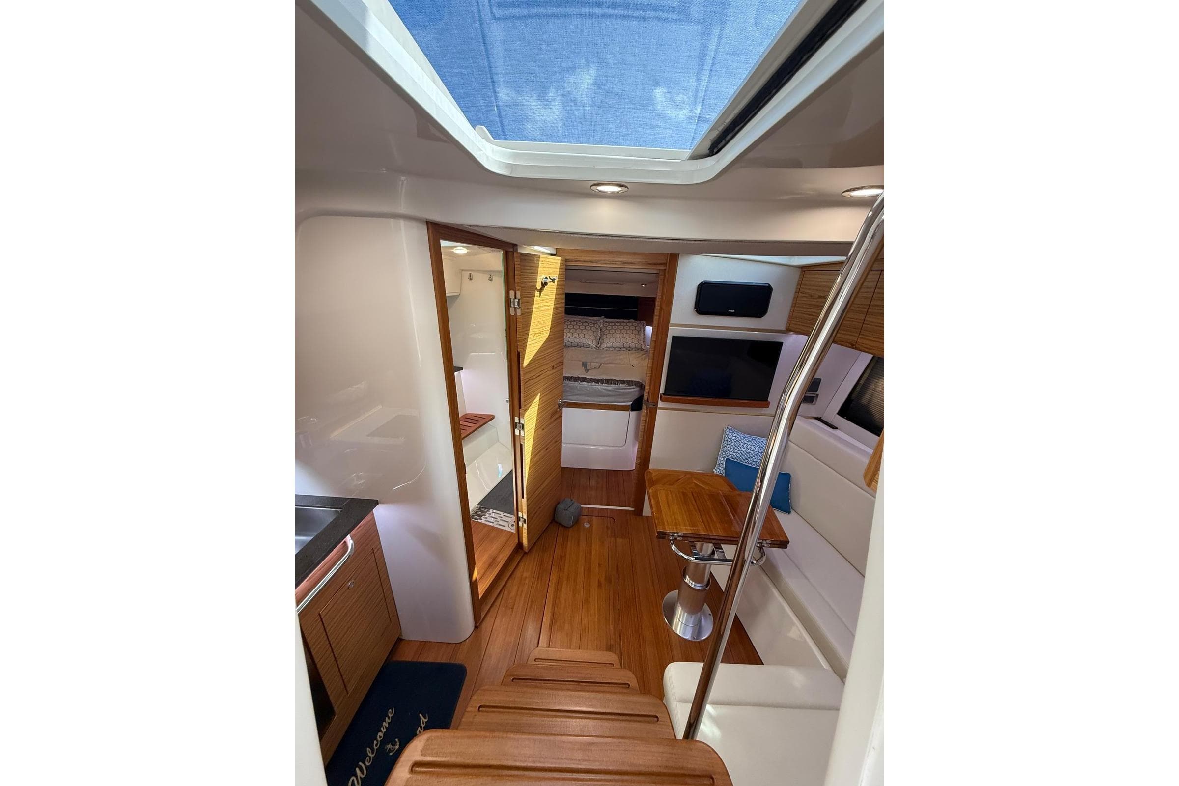 2024 Boston Whaler 405 Conquest interior with wood flooring and seating area.