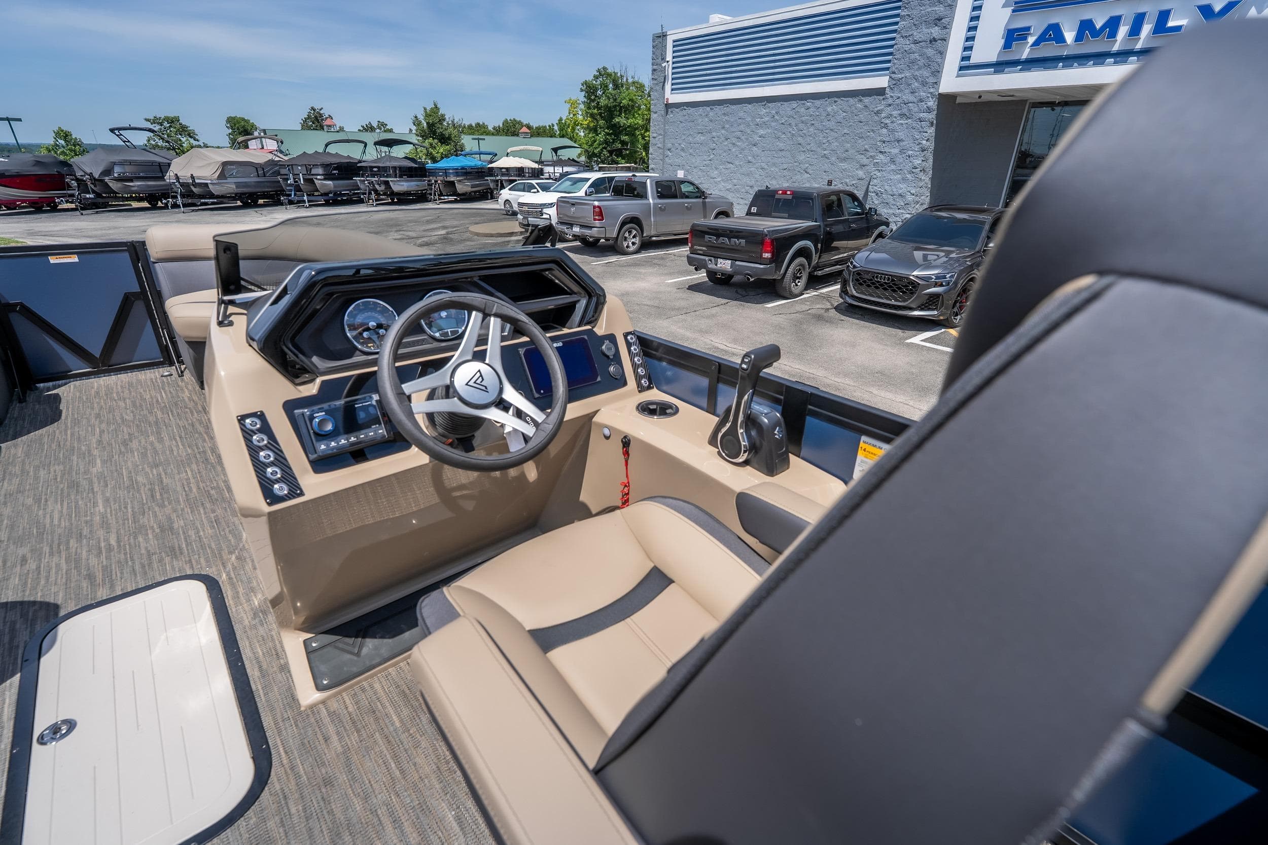 Interior of 2026 Viaggio X24U boat with modern steering and controls at dealership.