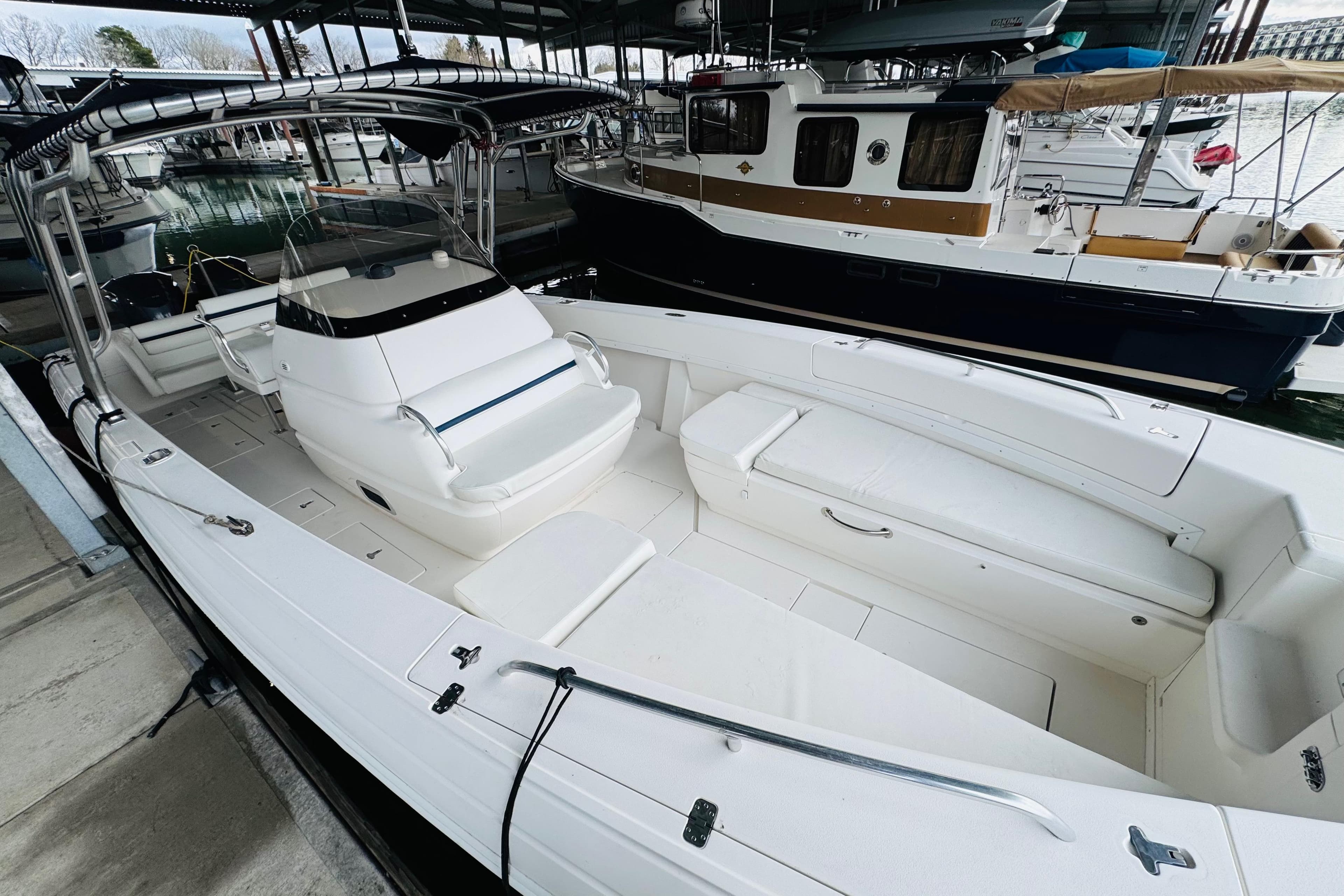 2008 Intrepid 327 boat docked, featuring spacious seating and sleek design.