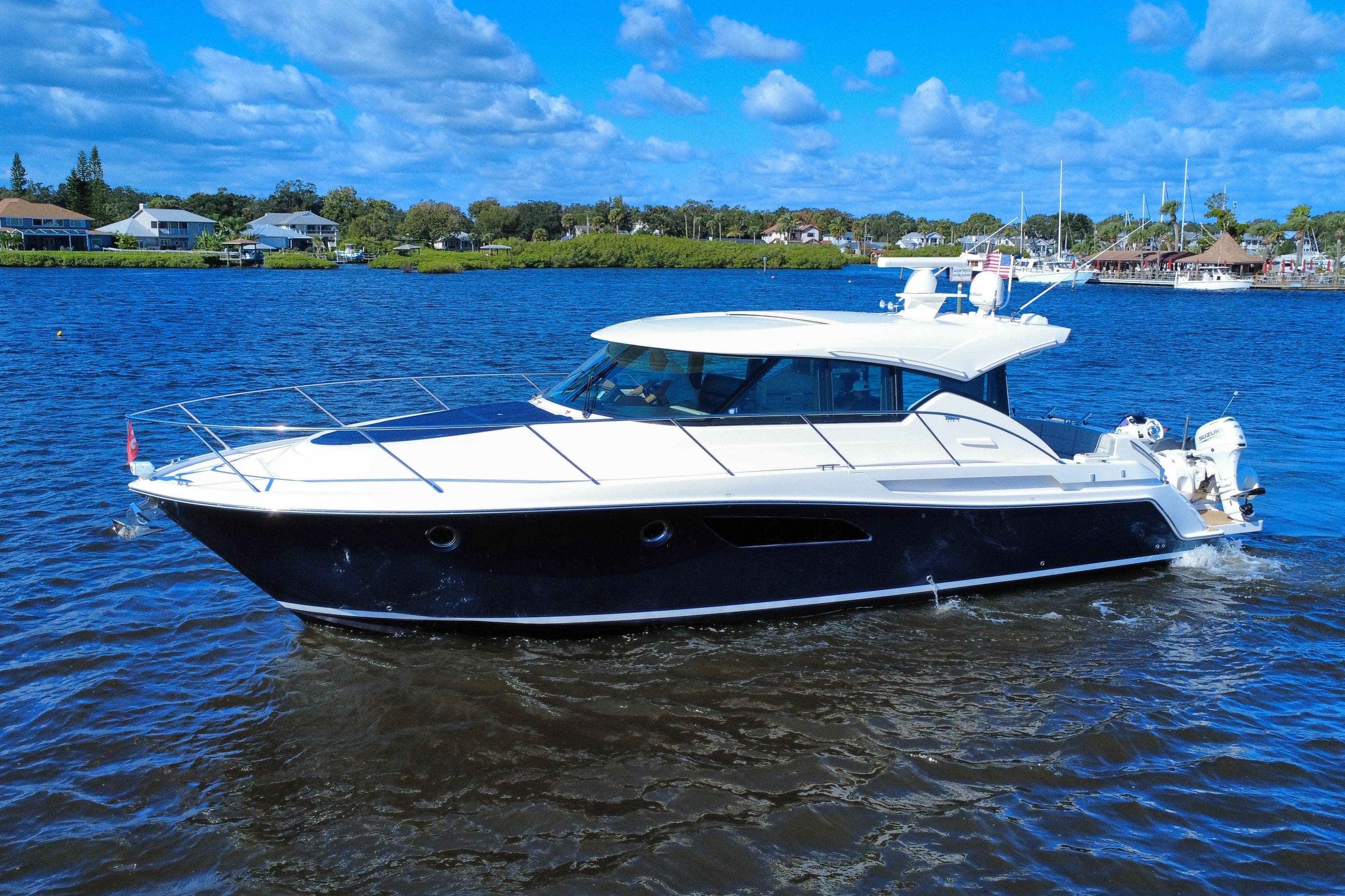 2016 Tiara Yachts C44 Coupe cruising on a sunny day with blue skies.