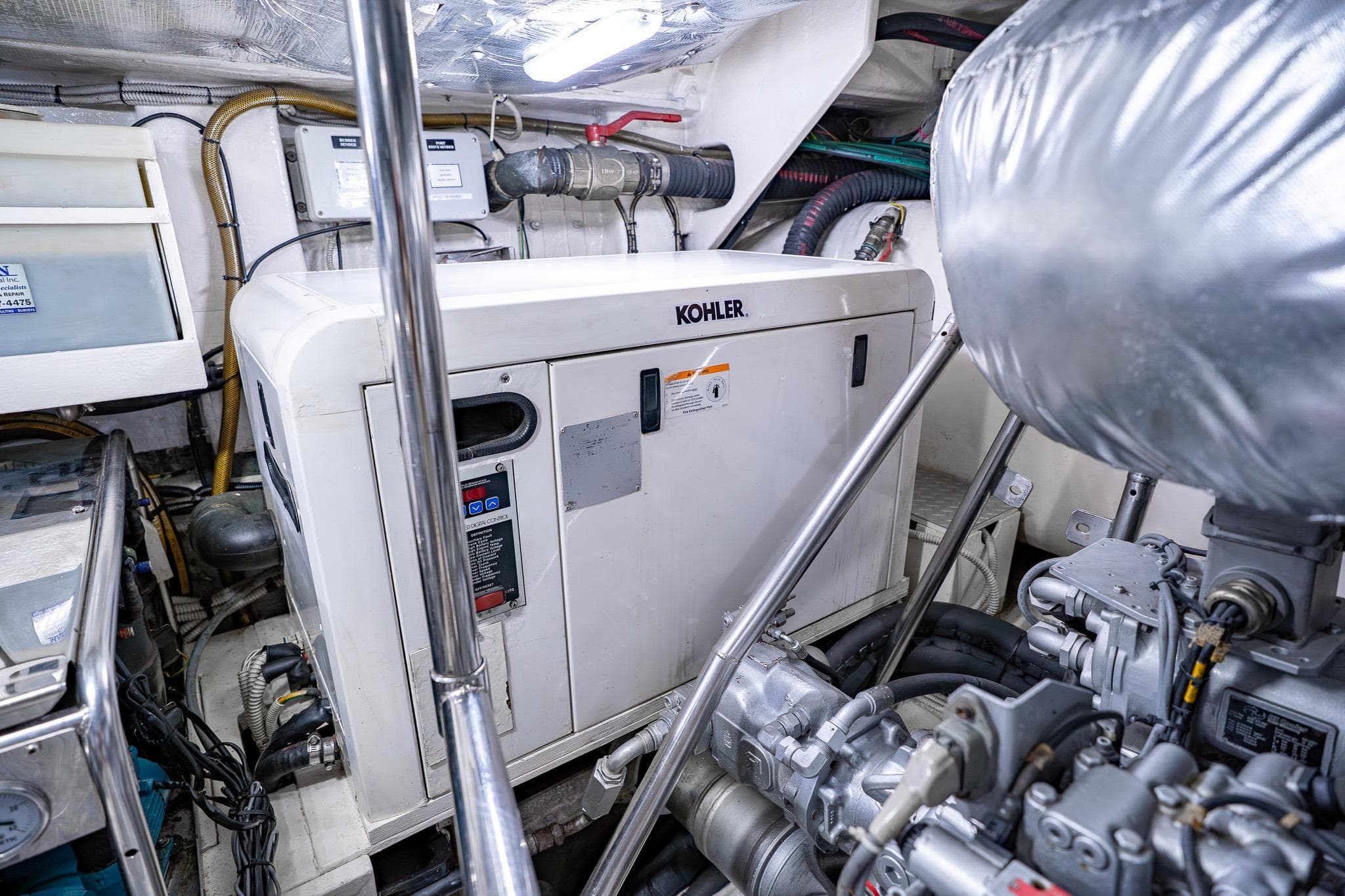 Engine room of a 2010 Pershing 80 yacht featuring a Kohler generator.