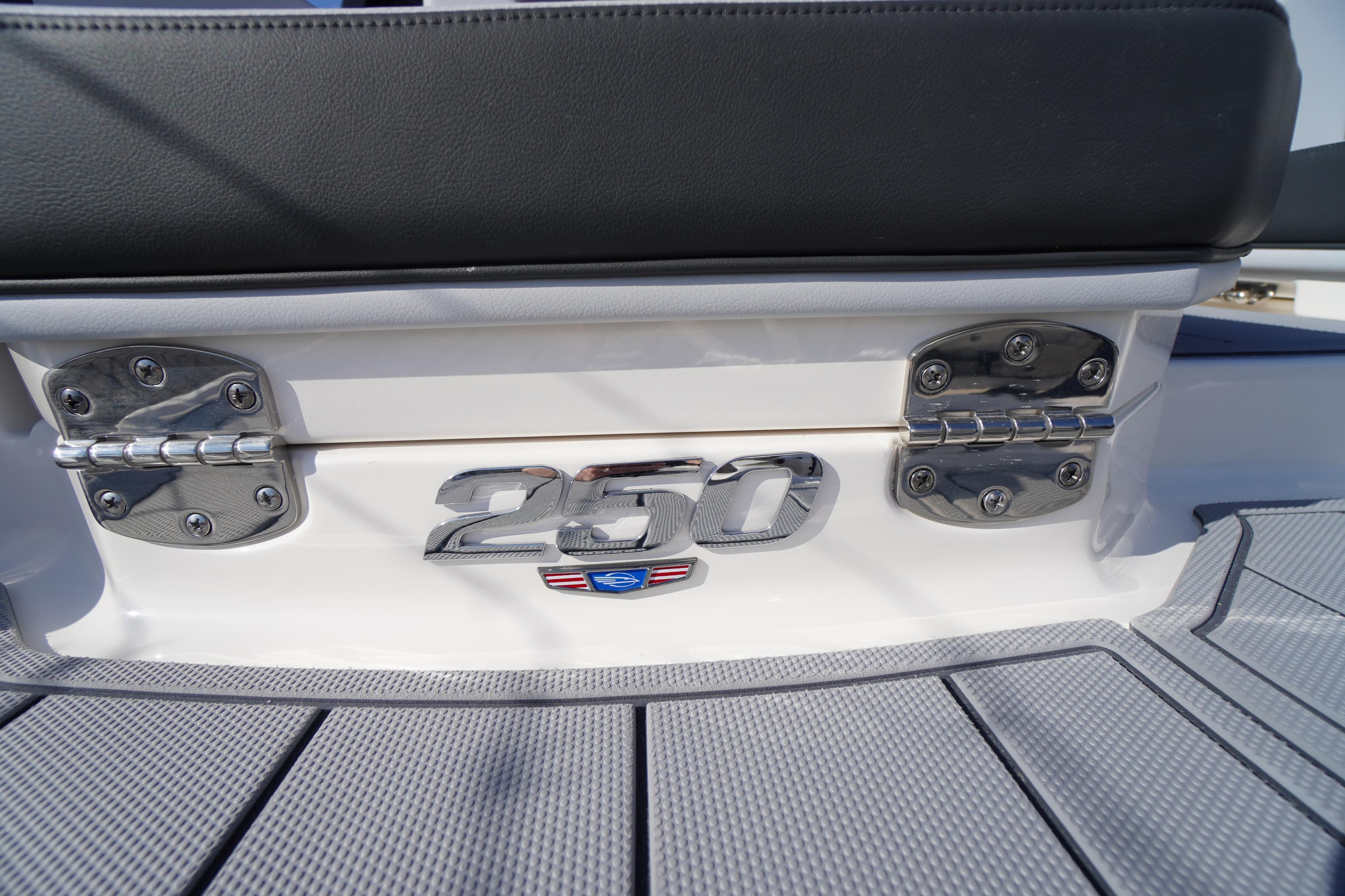 2026 Chaparral 250 OSX boat emblem on deck with stainless steel hinges.