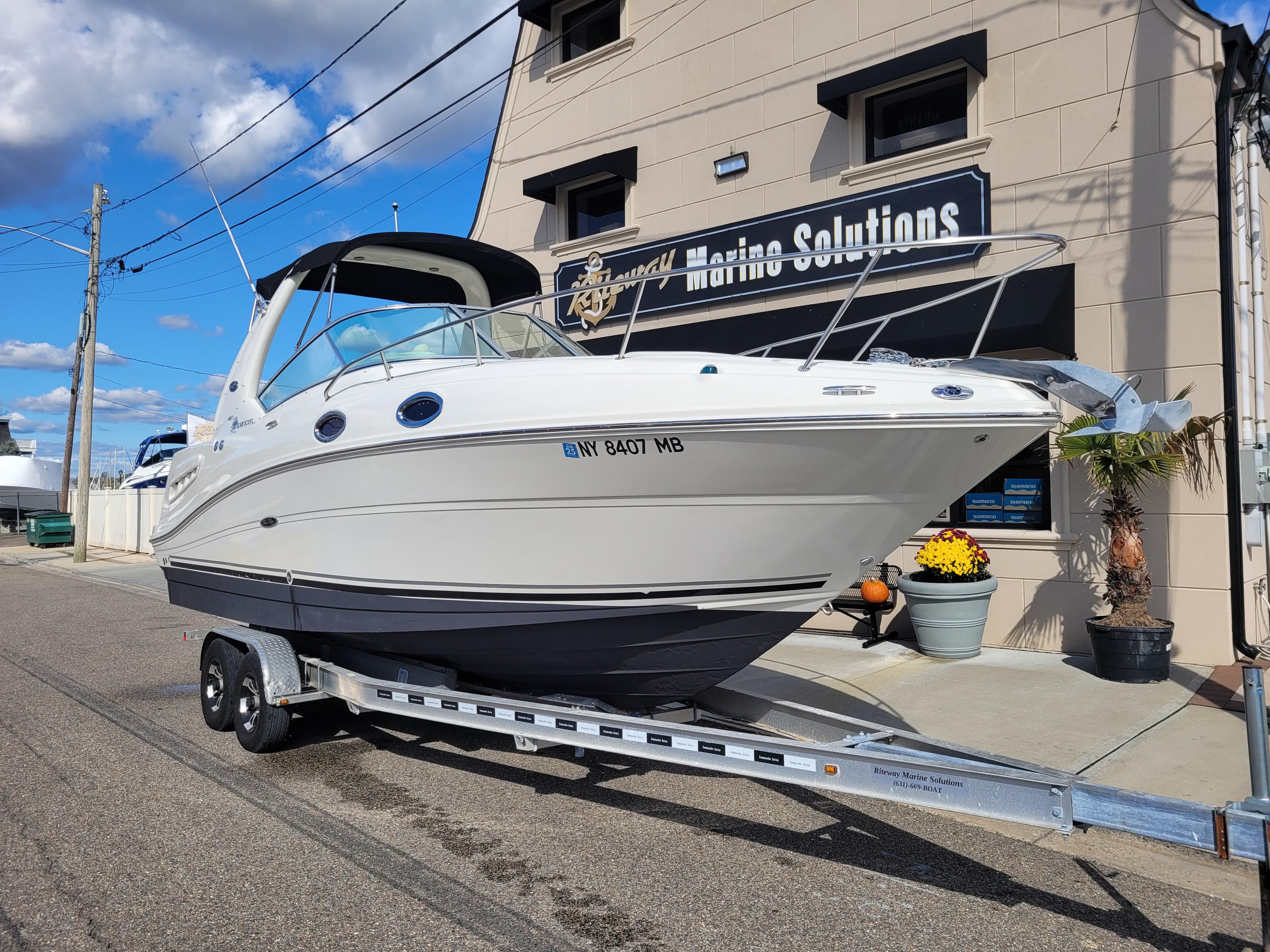 2007 Sea Ray 260 Sundancer boat on trailer outside marine solutions building.