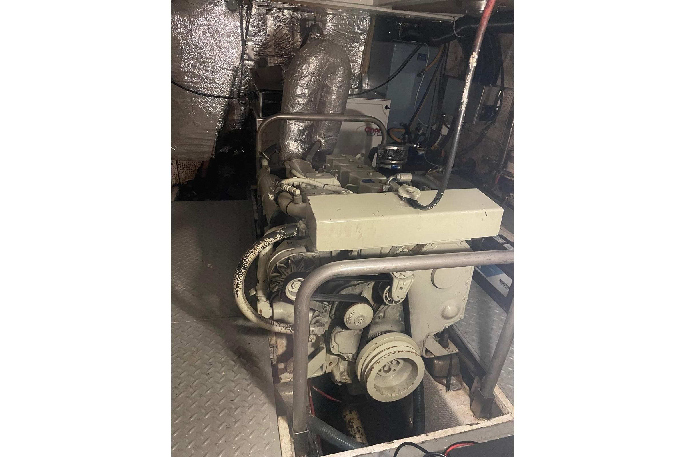 Engine room of 1980 Island Trader 46 yacht, featuring a well-maintained engine setup.