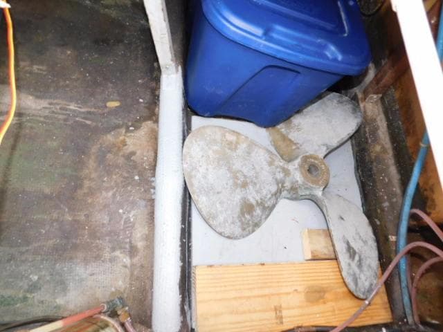 1976 Bertram 42 Convertible boat propeller and blue storage bin in cabin area.