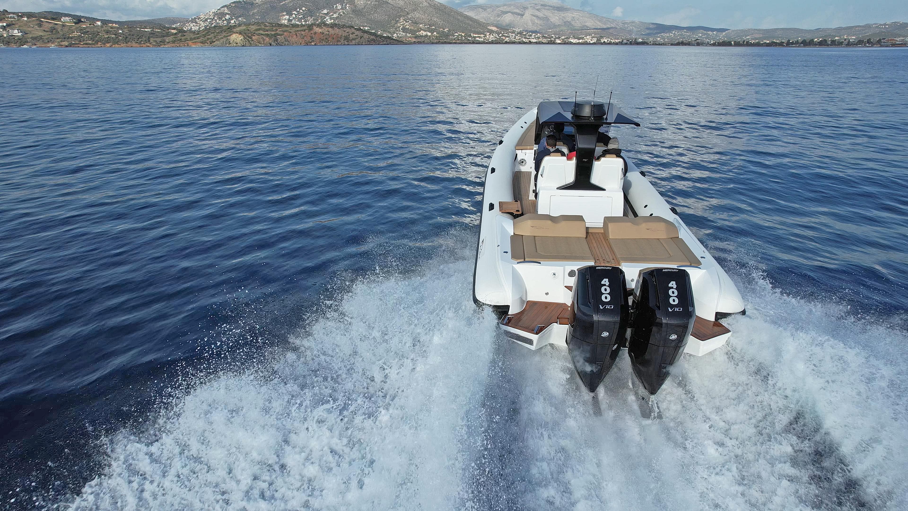 2024 Ribco Seafarer 36X boat cruising on open water, rear view.