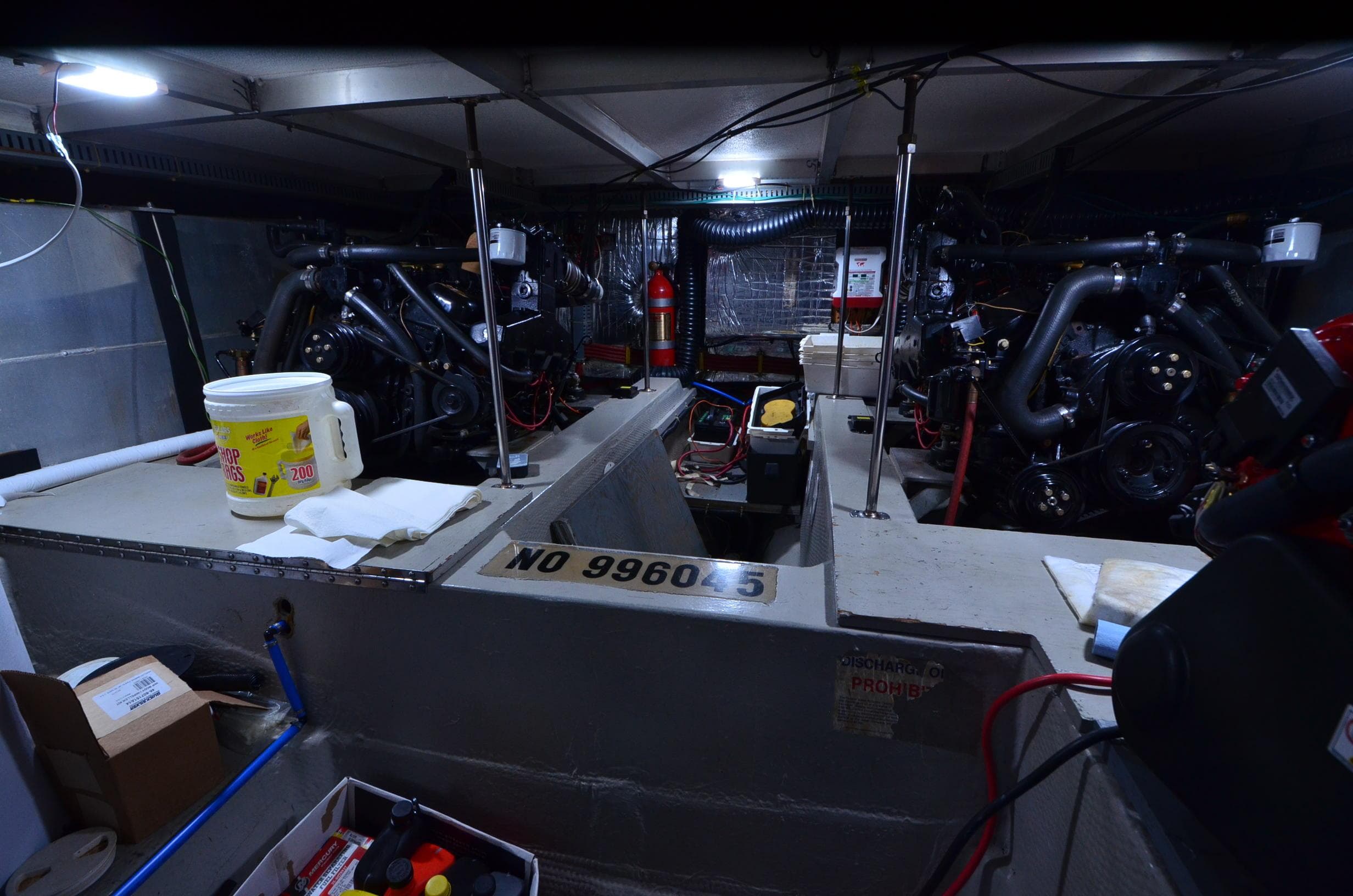 Engine room of 1988 Carver 4207 Aft Cabin MY with visible equipment and tools.