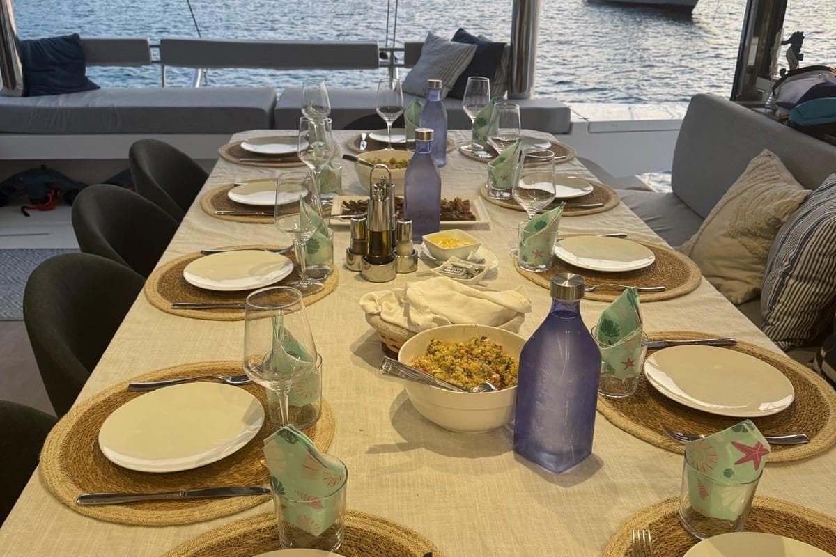 Elegant dining setup on Bali 5.4 Open Space yacht, 2021, with ocean view.