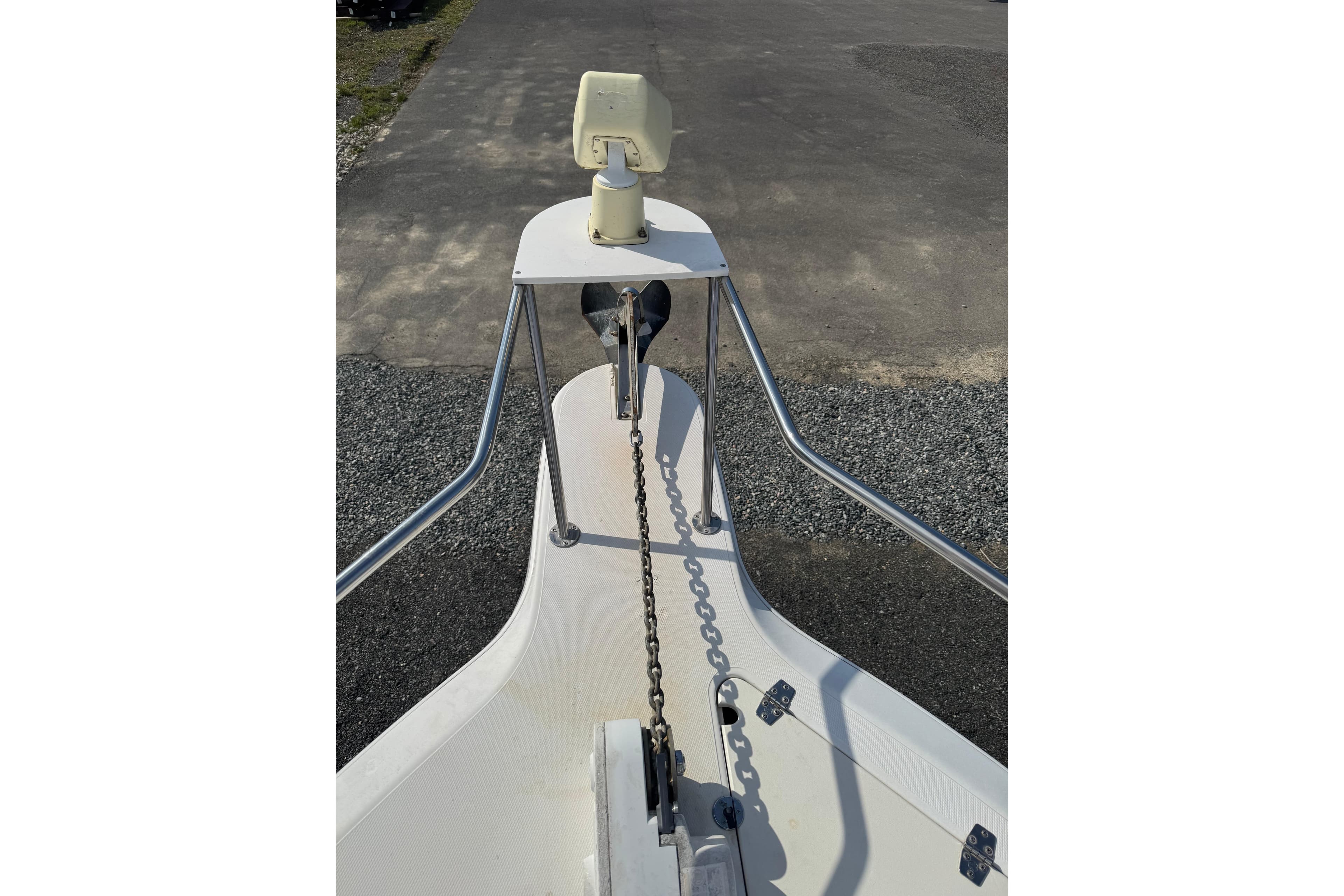 Bow view of a 2000 Sport-Craft 241 Walk Around boat with anchor chain.