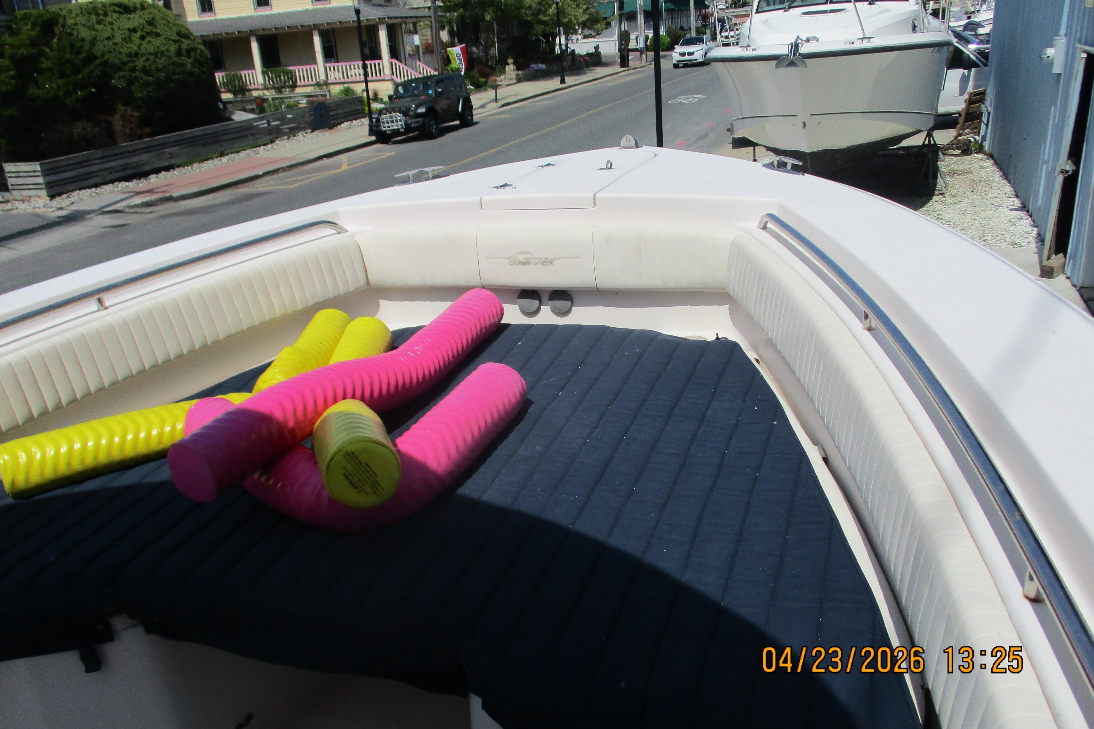 2007 Grady-White Bimini 306 boat with colorful pool noodles on deck.