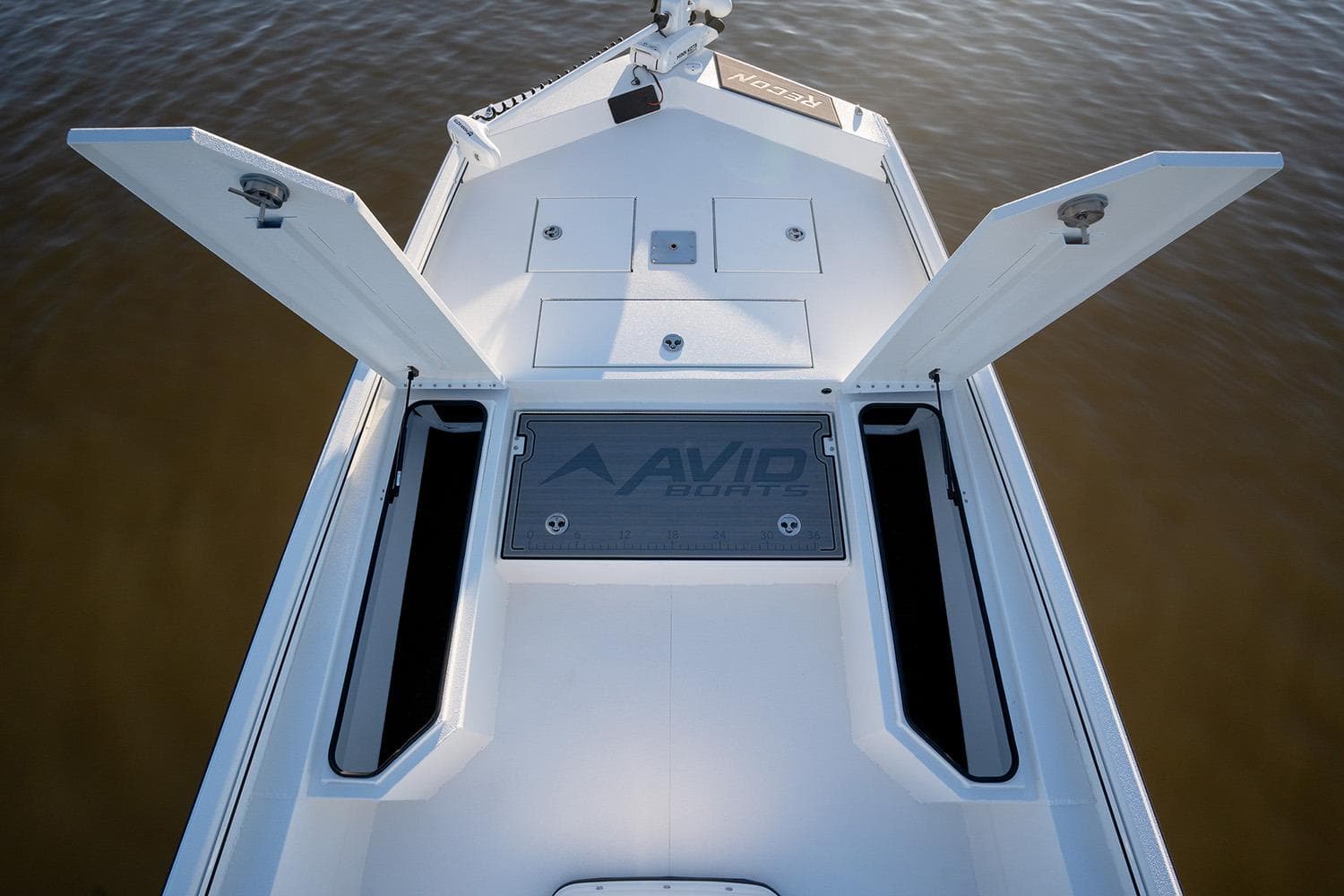 Manufacturer Provided Image: Avid 207 Recon 2026 boat deck with open storage compartments on calm water.