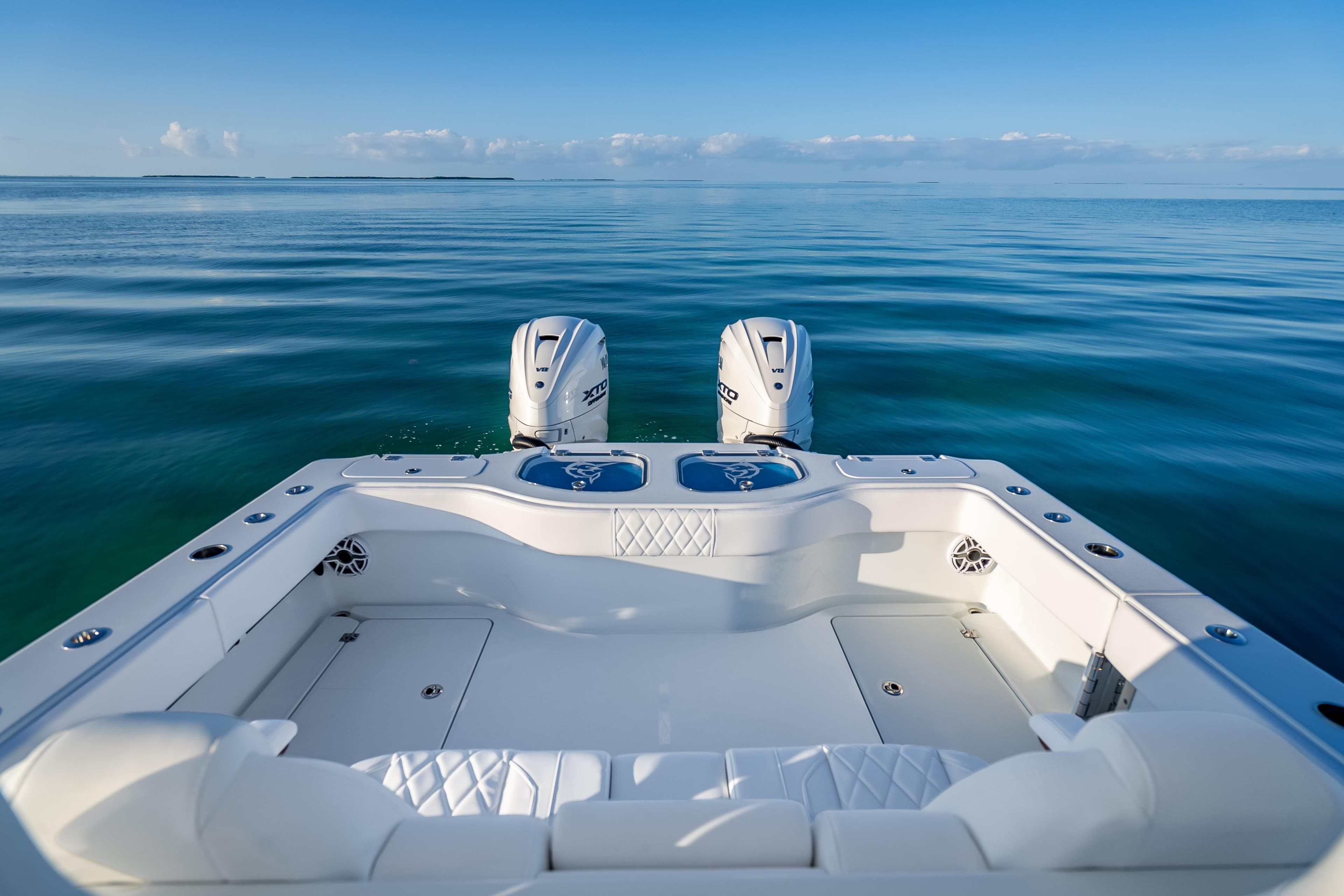 2026 Freeman 35 boat with dual engines on calm ocean waters.