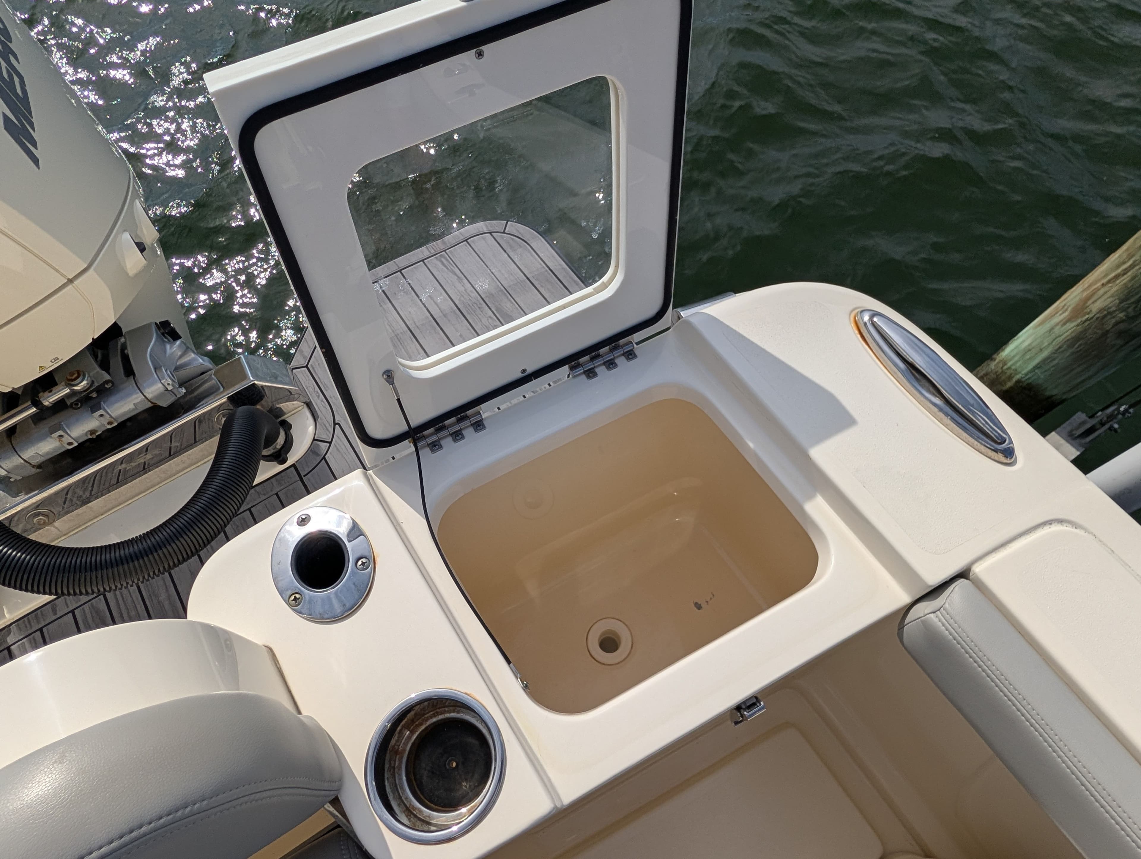 2024 Scout 277 LXF boat with open storage compartment at the stern.