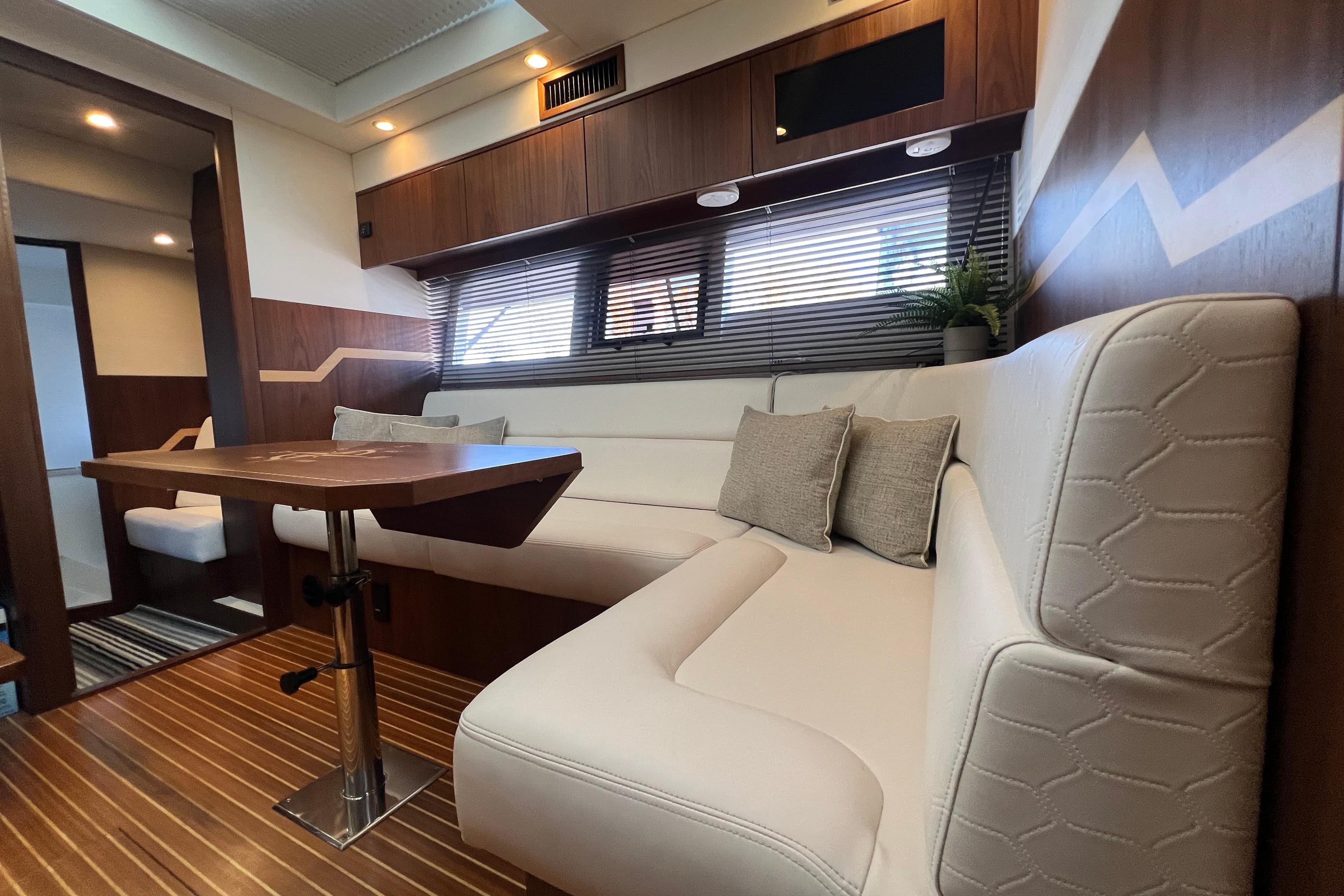 Luxurious interior of 2016 Galeon 405 HTS yacht with elegant seating and wooden accents.