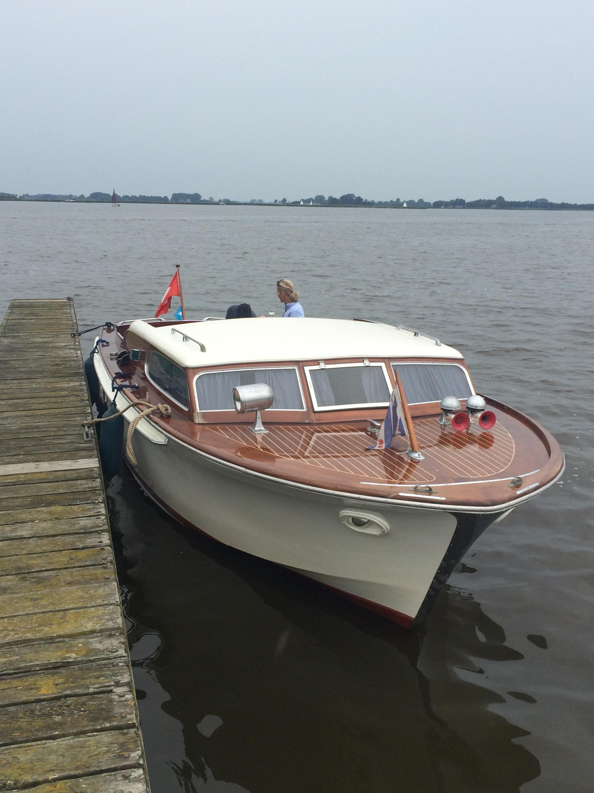 Vintage 1962 Swiss Craft 820 boat docked on a calm lake.