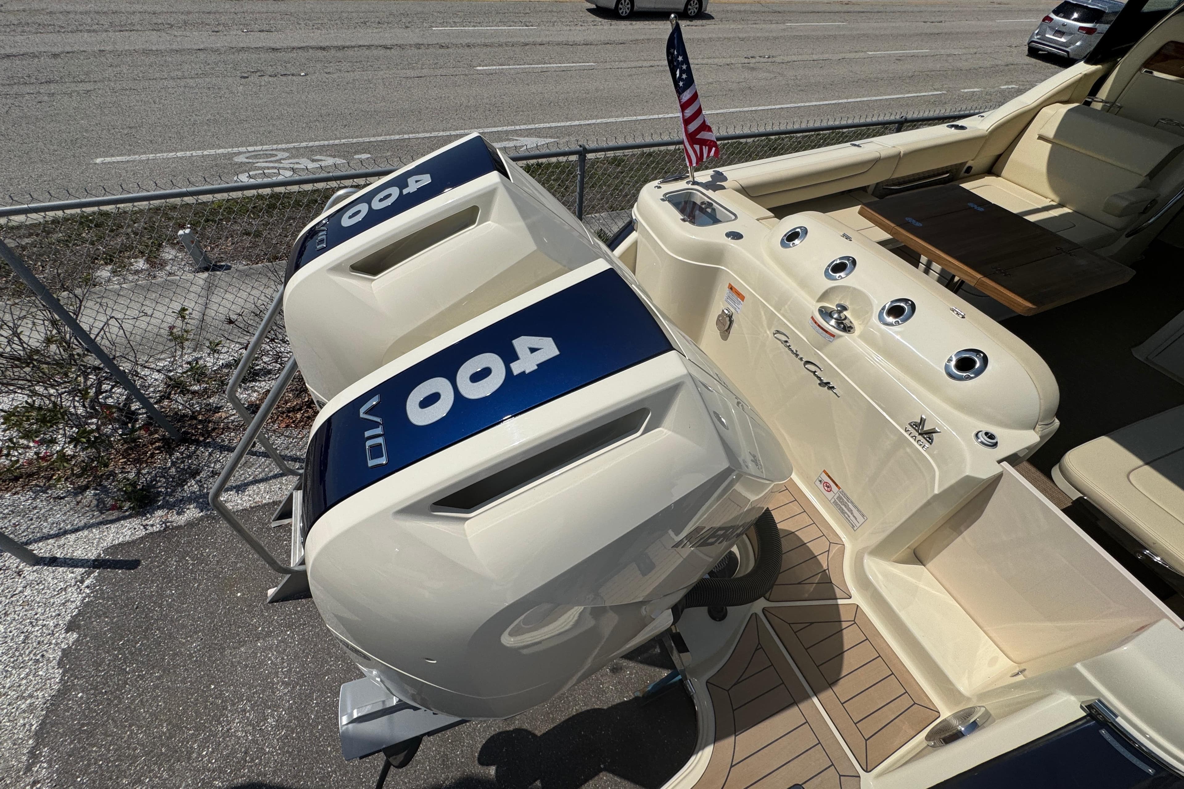 2026 Chris-Craft Calypso 32 boat with dual 400 V10 engines, docked with American flag.