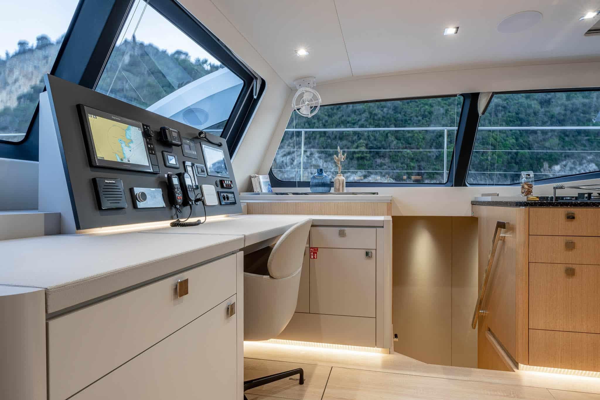 Luxurious interior of 2025 Privilege Signature 580 yacht with modern navigation station.