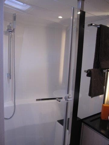 Modern bathroom in 2024 Jeanneau 55 yacht with sleek shower and contemporary fixtures.