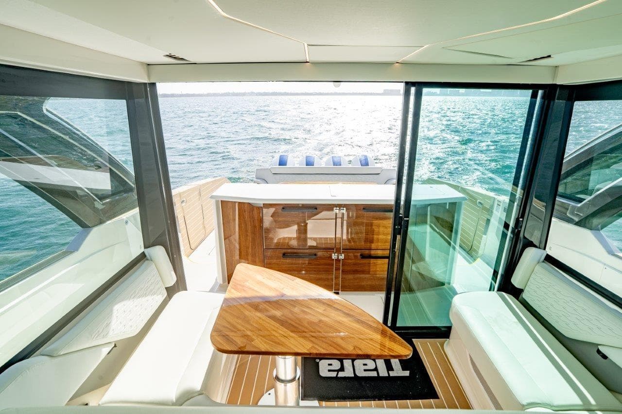 Interior view of 2026 Tiara Yachts 56 LS, featuring elegant seating and ocean backdrop.