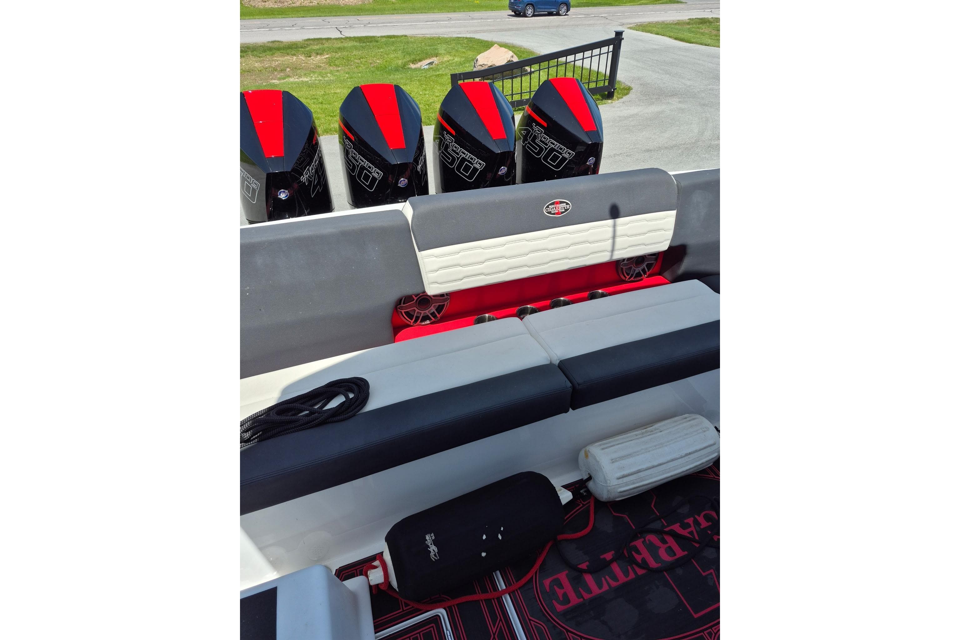 2021 Cigarette 41' Nighthawk boat with four powerful outboard engines, sleek seating, and modern design.