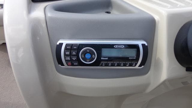 2014 Avalon Wind Jammer boat dashboard with stereo system.