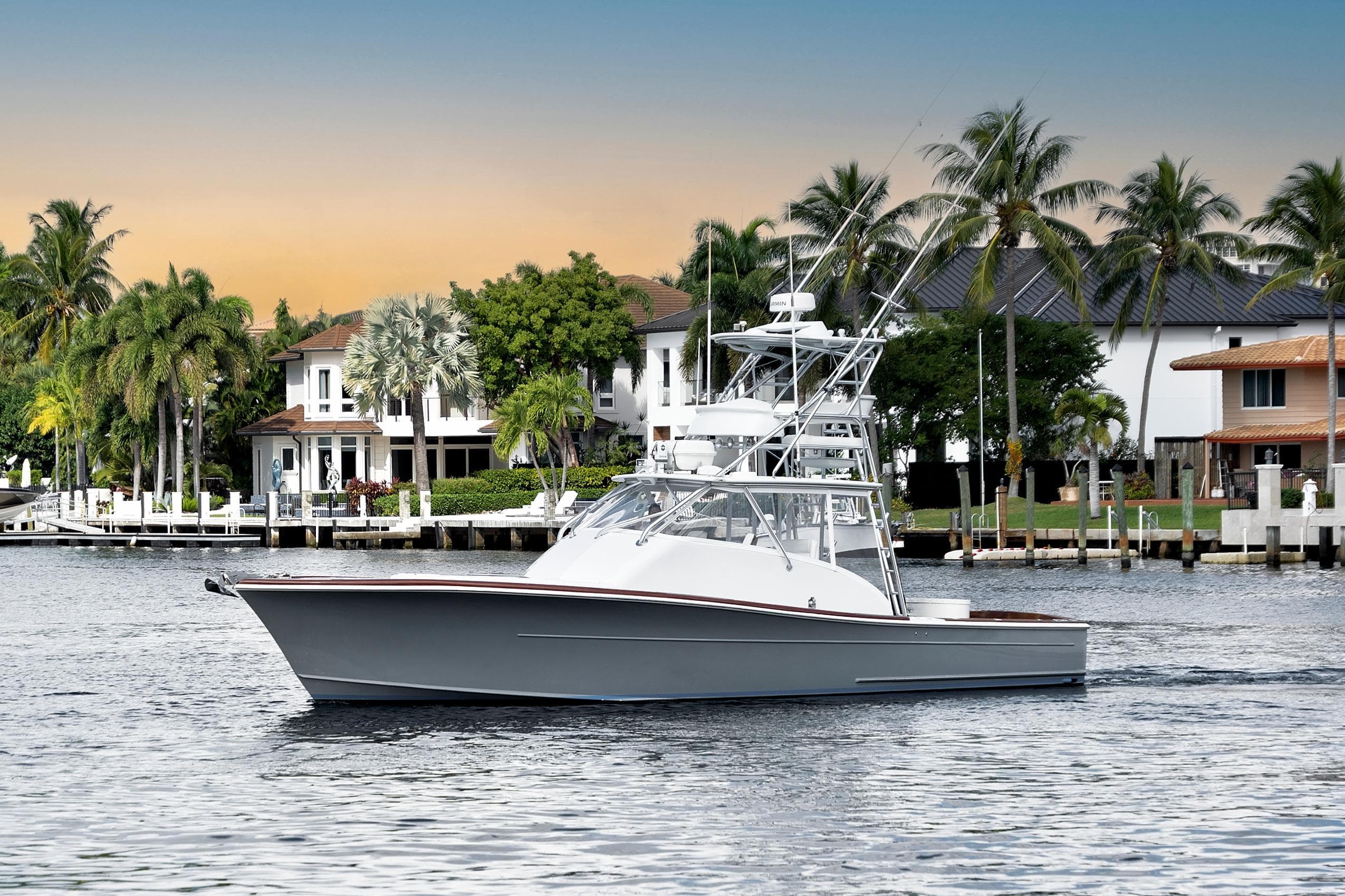 2014 Release Walkaround boat cruising near waterfront homes at sunset.