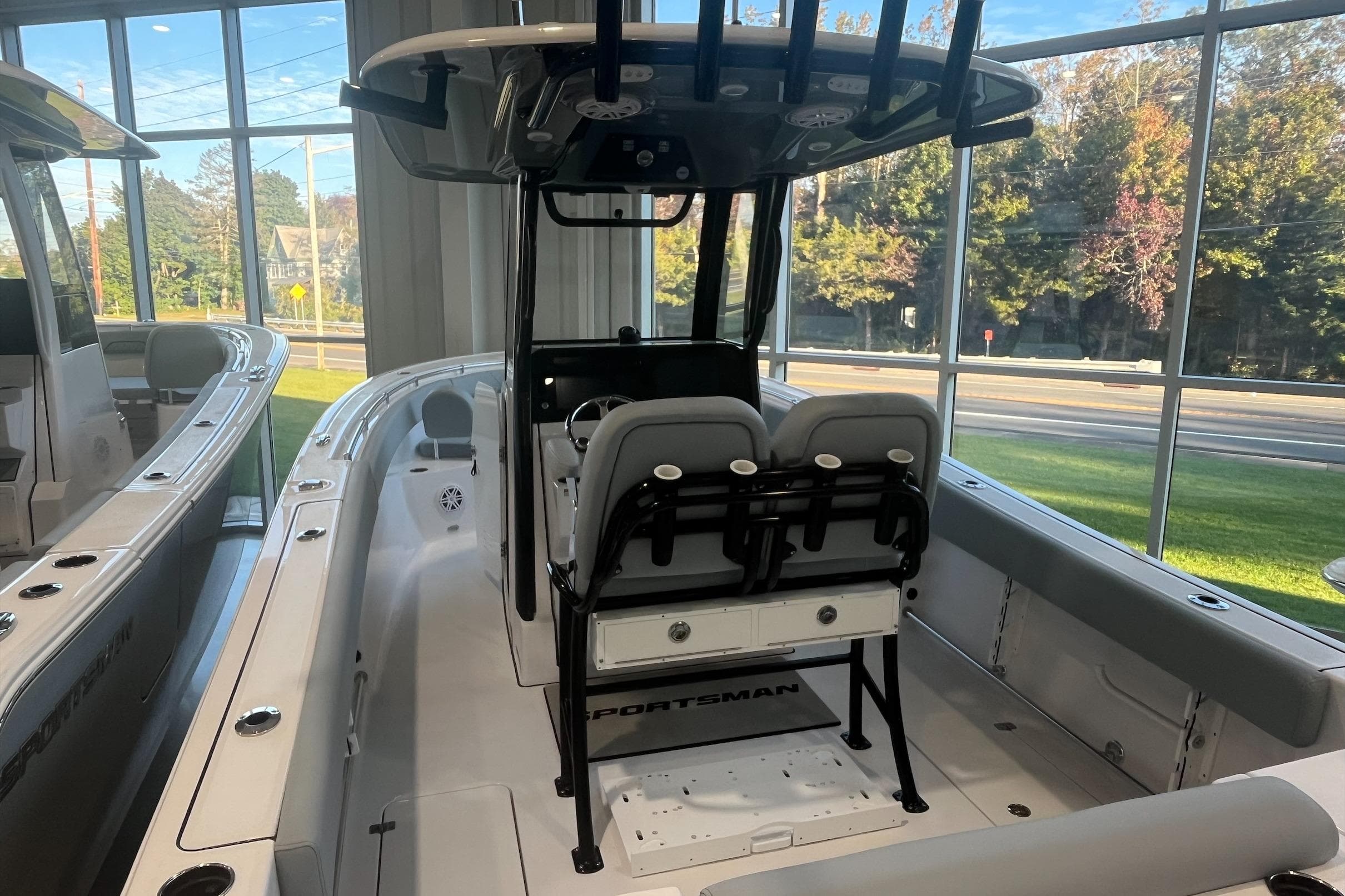 2026 Sportsman Open 252 Center Console boat in showroom, featuring sleek design and modern amenities.