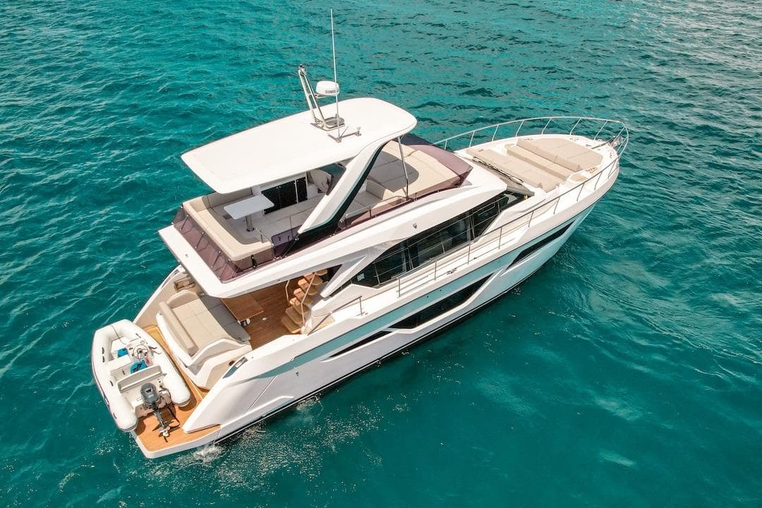 2024 Ferretti Yachts 580 cruising on clear blue water.