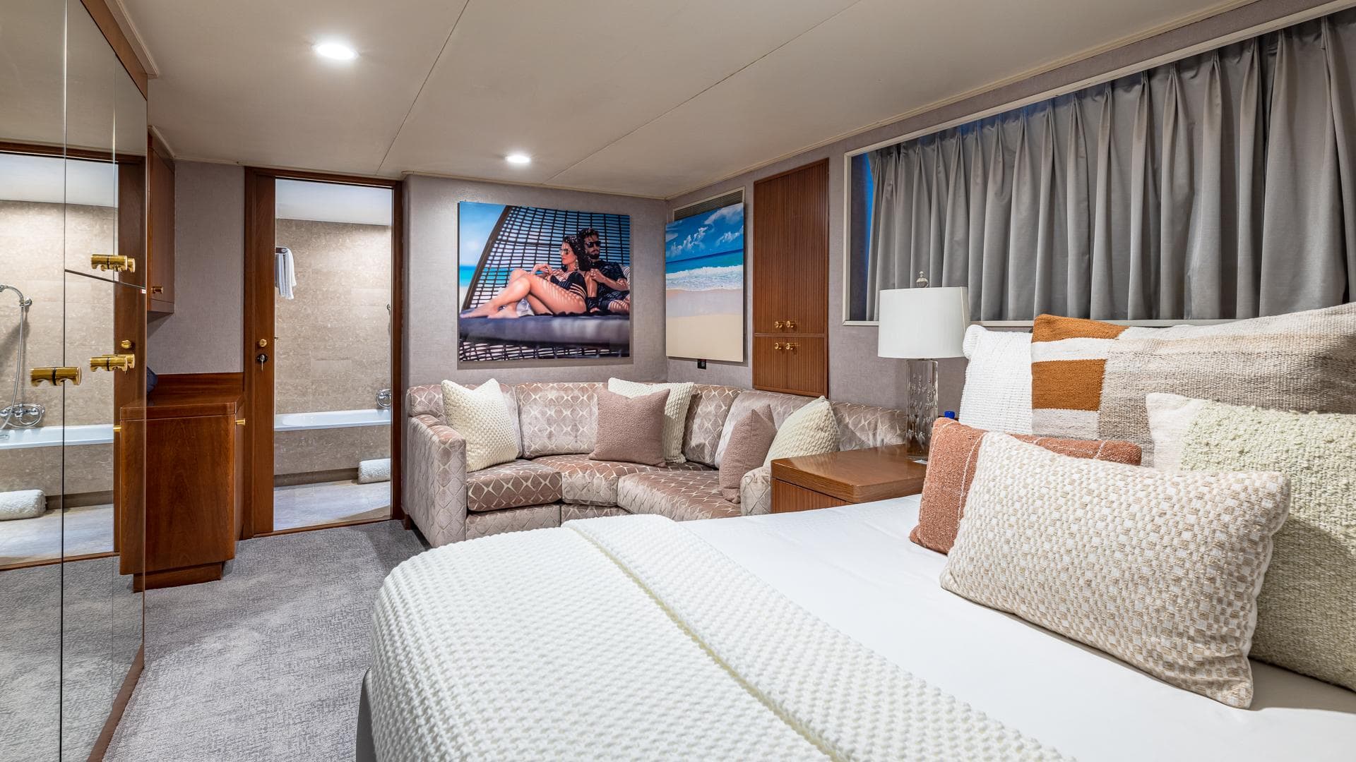 Luxurious 1985 Feadship Custom yacht bedroom with elegant decor and cozy seating area.