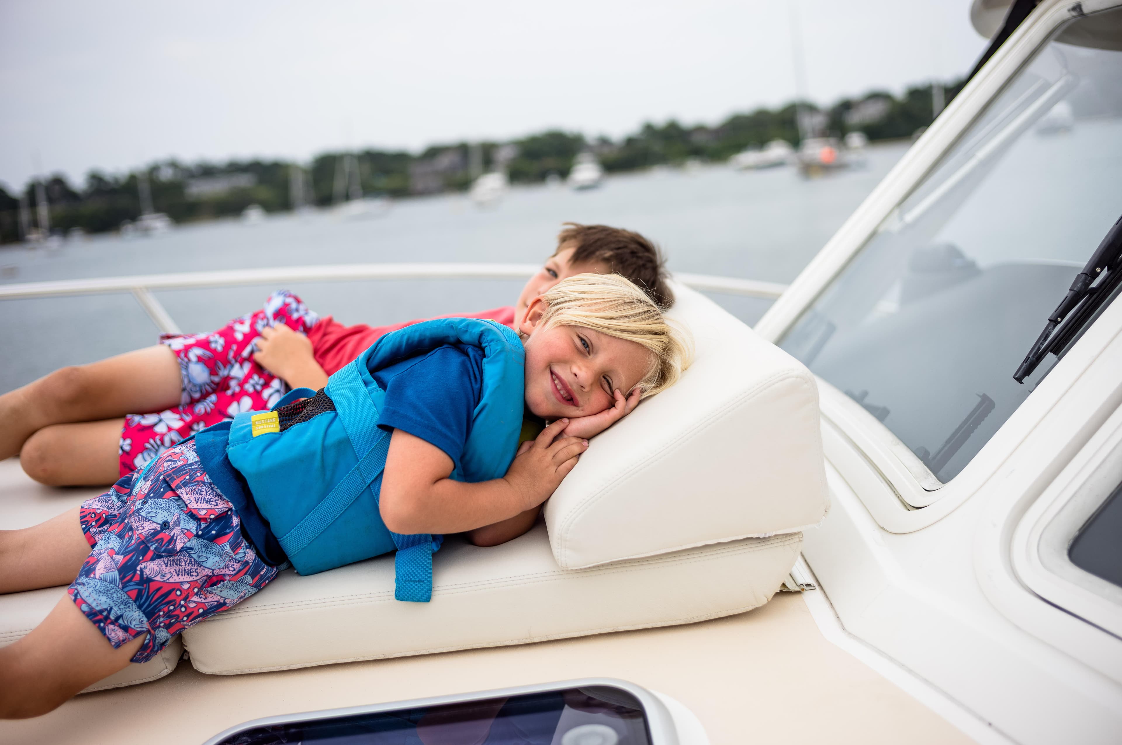 Children relaxing on a 2020 MJM 53z boat, enjoying a sunny day on the water.