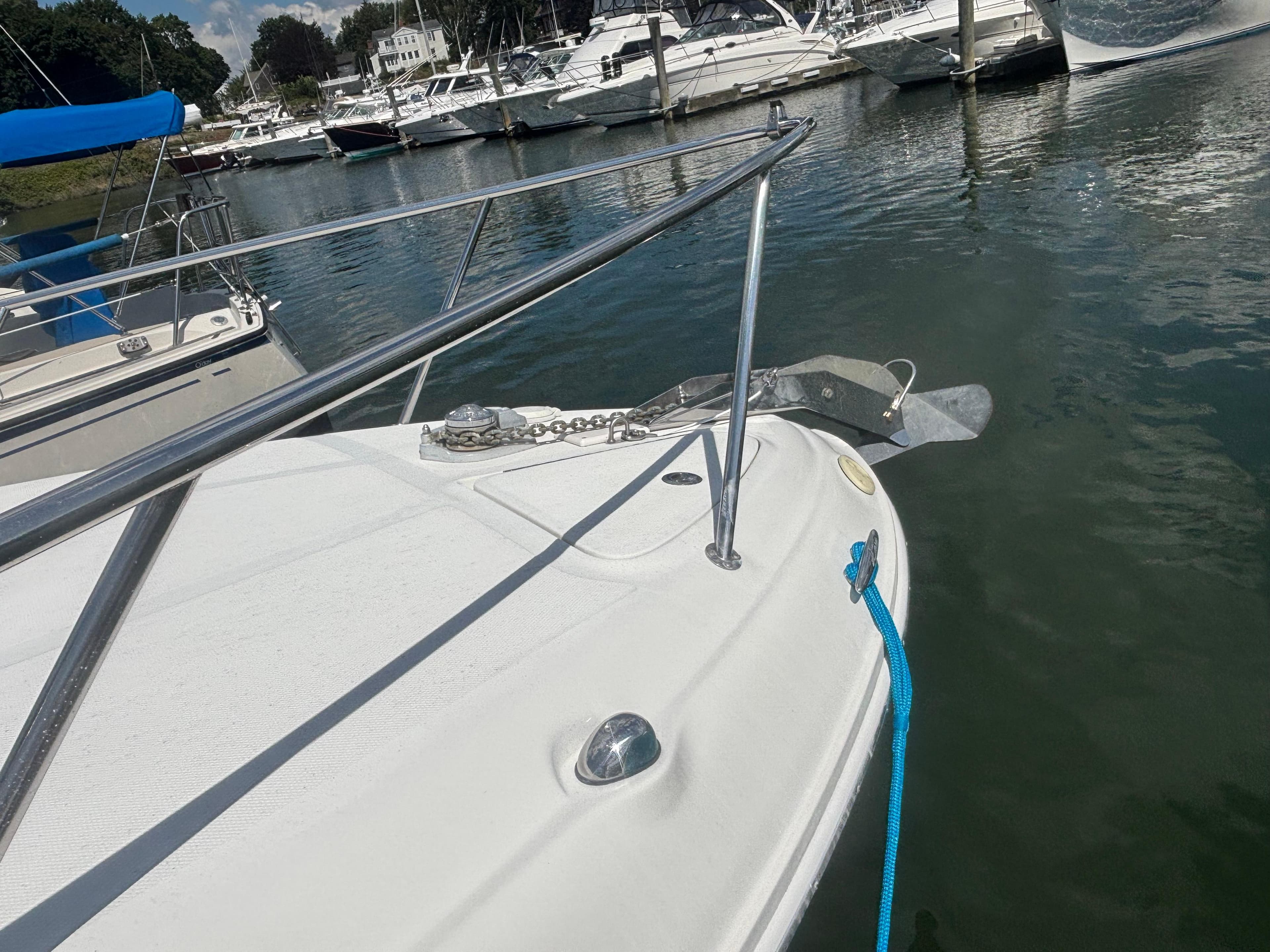 2006 Sea Ray 260 Sundancer docked in a marina, featuring a blue mooring line.
