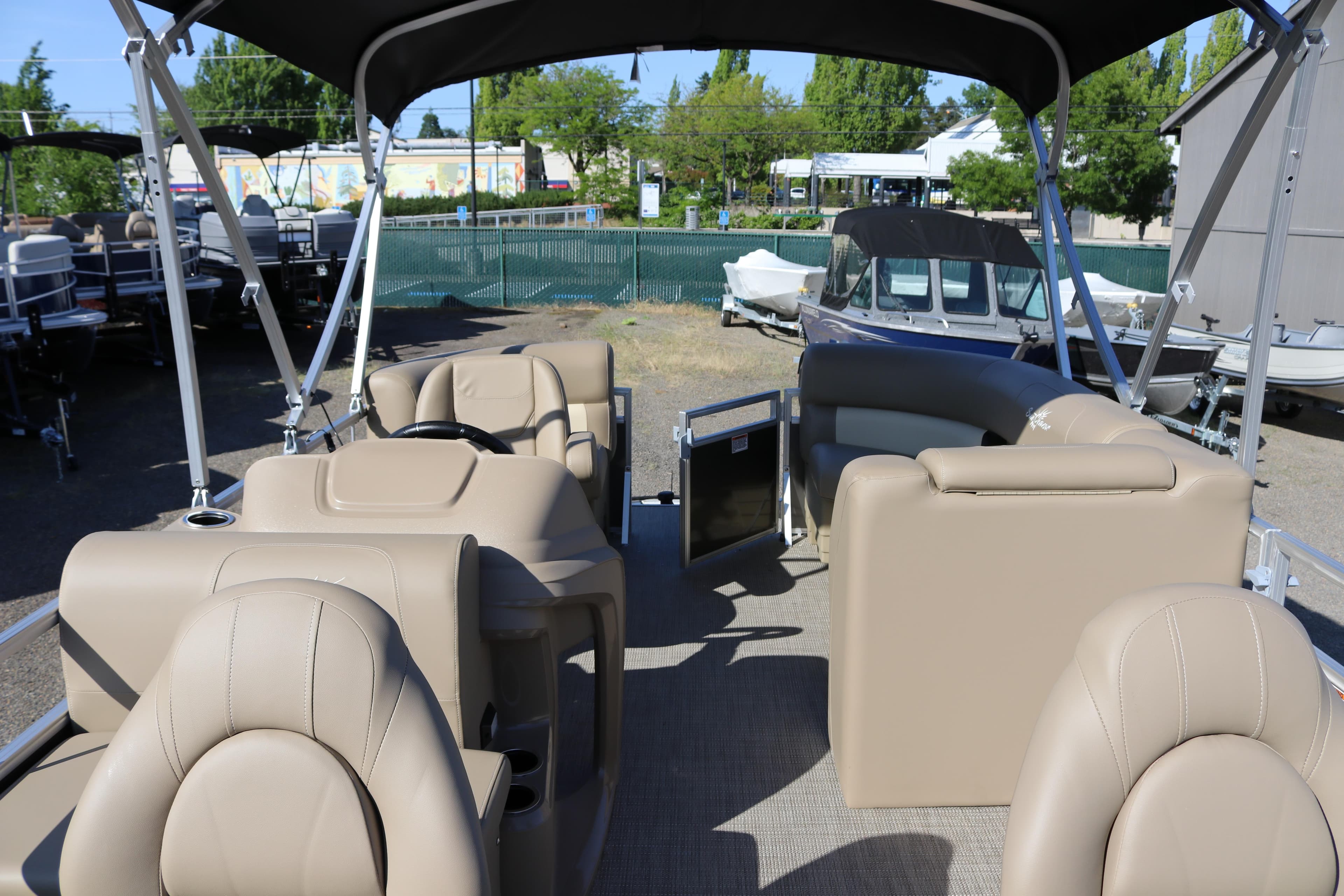 2025 SunChaser Vista 18 Fish pontoon boat interior with beige seating and canopy.