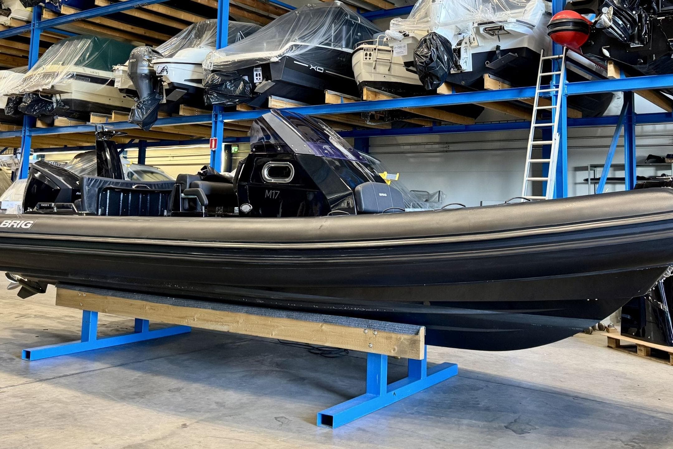2019 Brig 8 inflatable boat in storage, surrounded by other vessels.