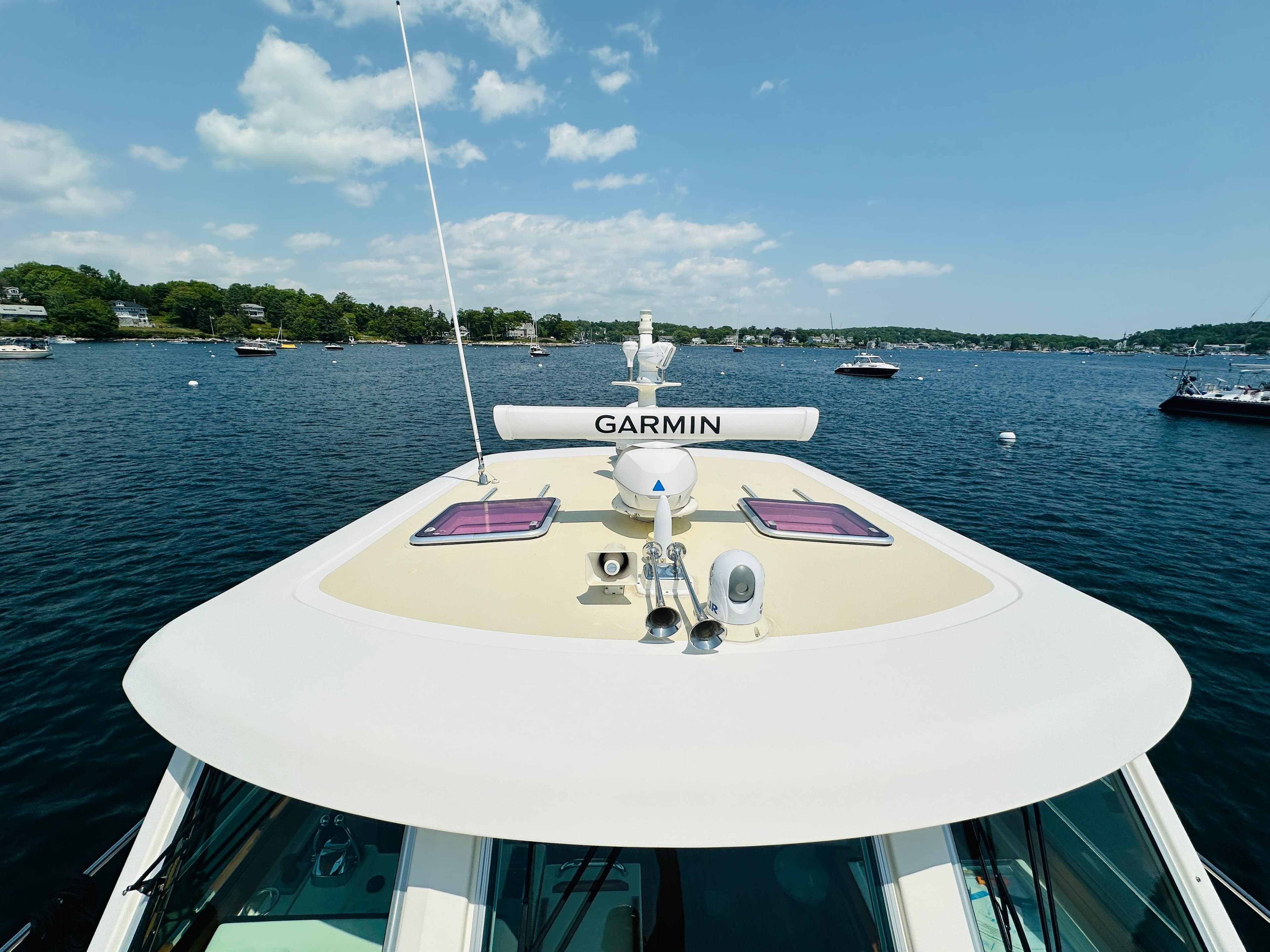 2008 Sabre 42 Hardtop Express yacht on water, featuring Garmin equipment, under clear sky.