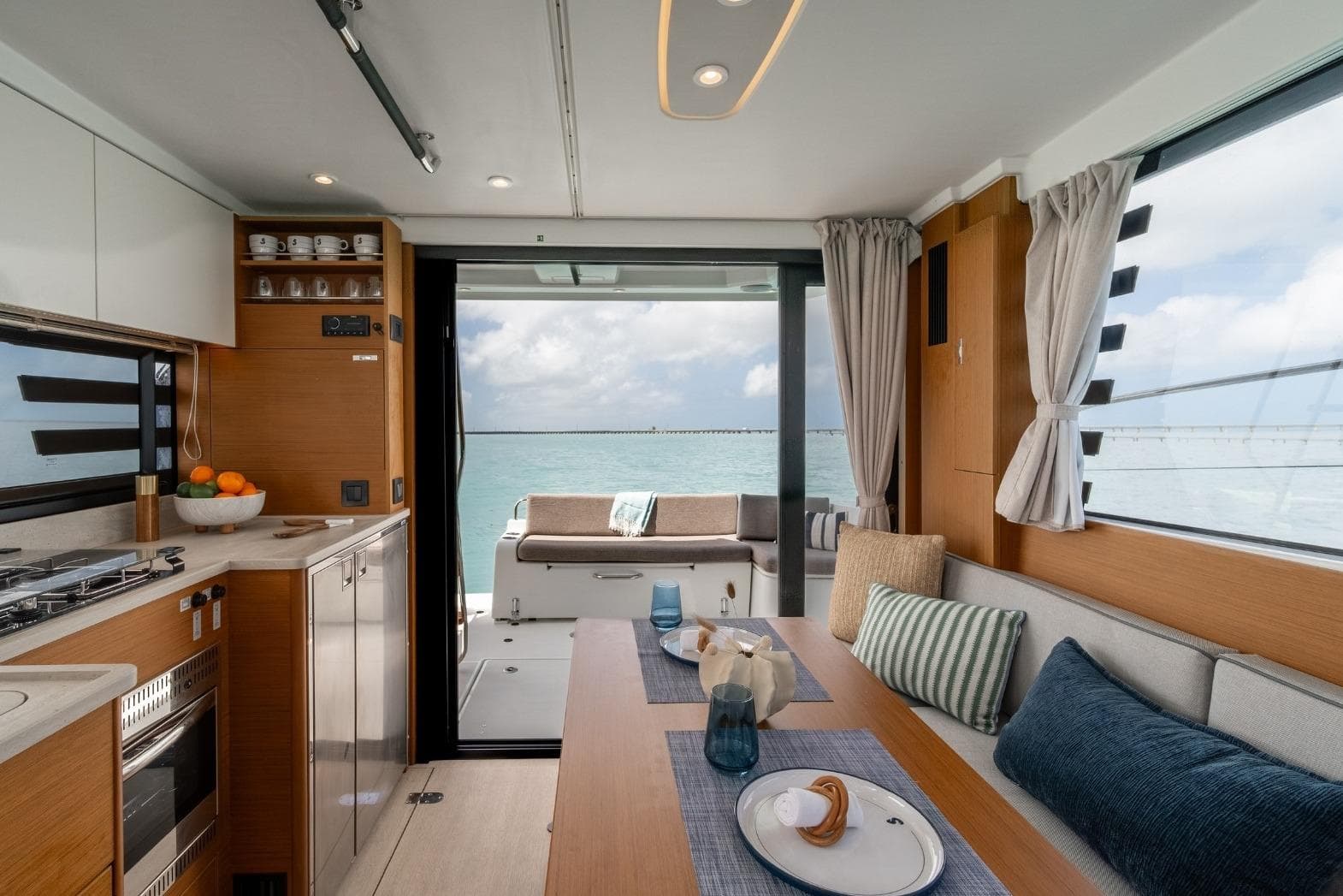 Interior of 2027 Beneteau Swift Trawler 37 Fly, featuring modern kitchen and dining area.