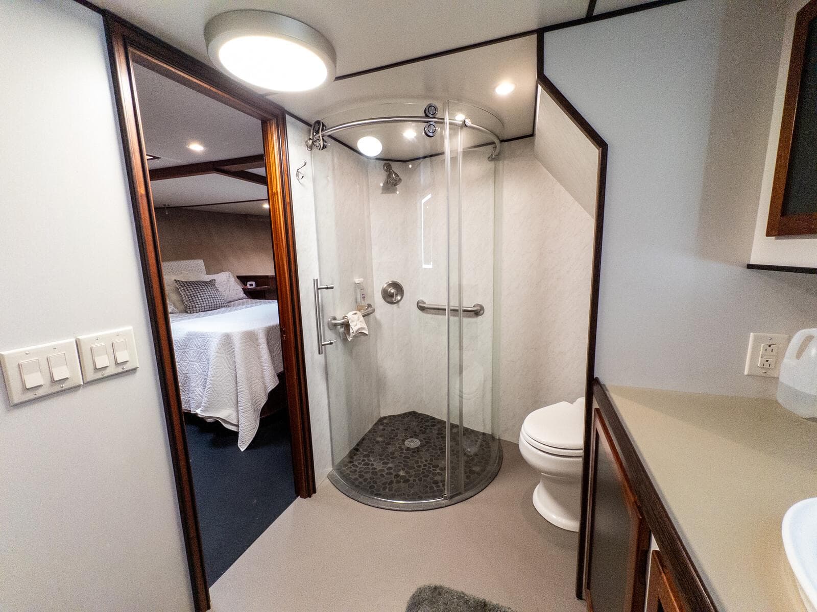 Luxurious bathroom in 1986 Custom Expedition Vessel 58 with modern shower and adjacent bedroom.