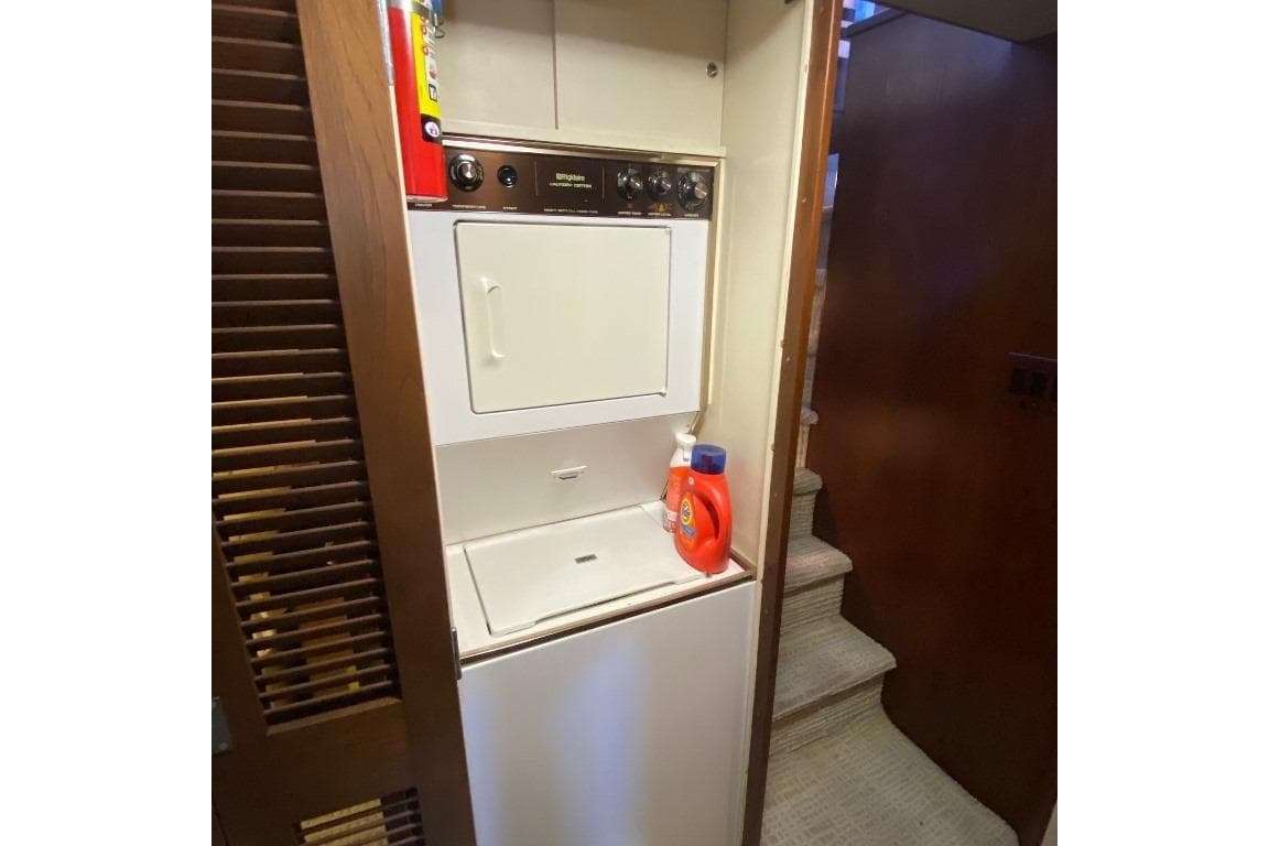 Laundry area on 1988 Burger 80 Motor Yacht with washer, dryer, and detergent.