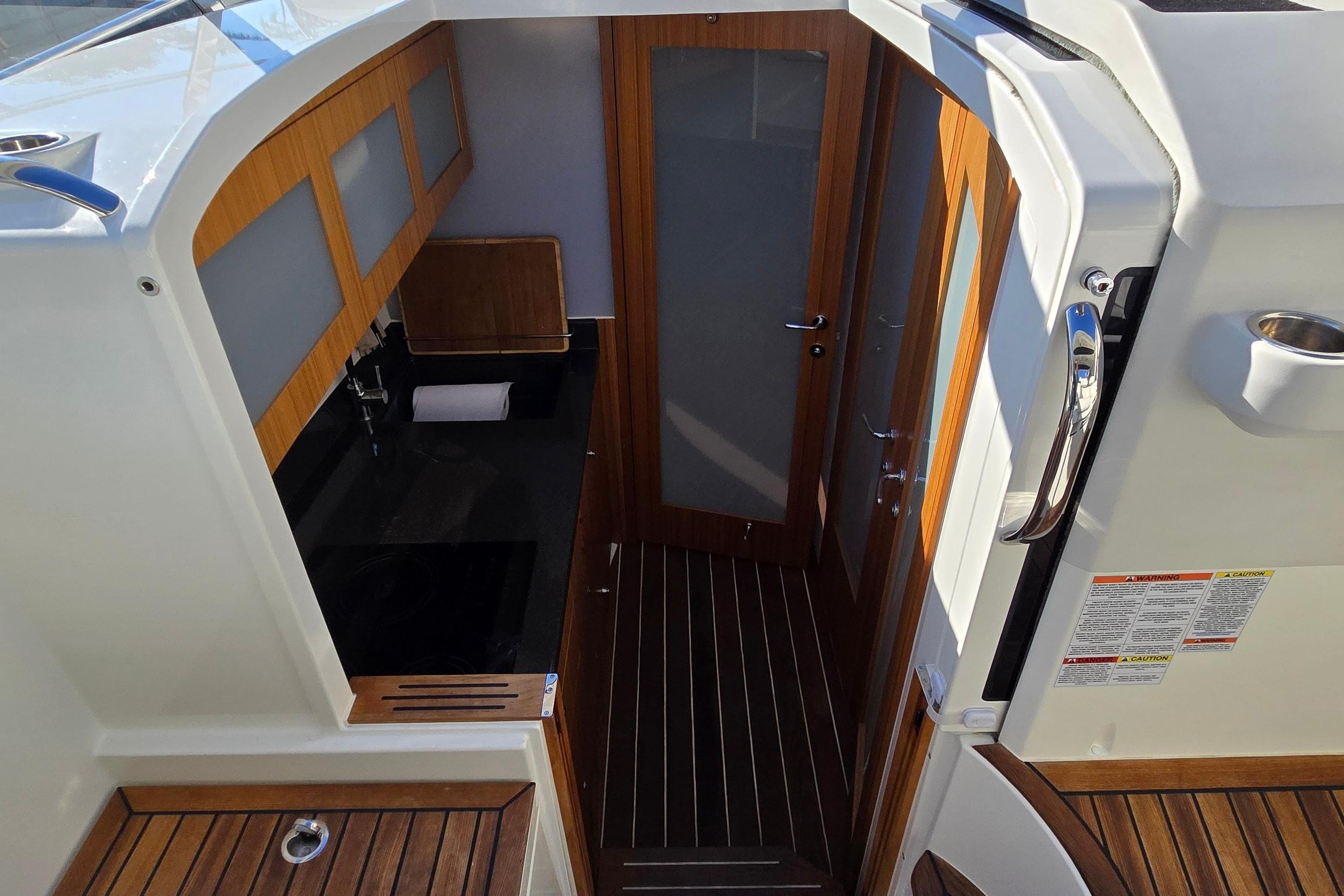 2025 Marex 310 Sun Cruiser interior with wood accents and modern design.