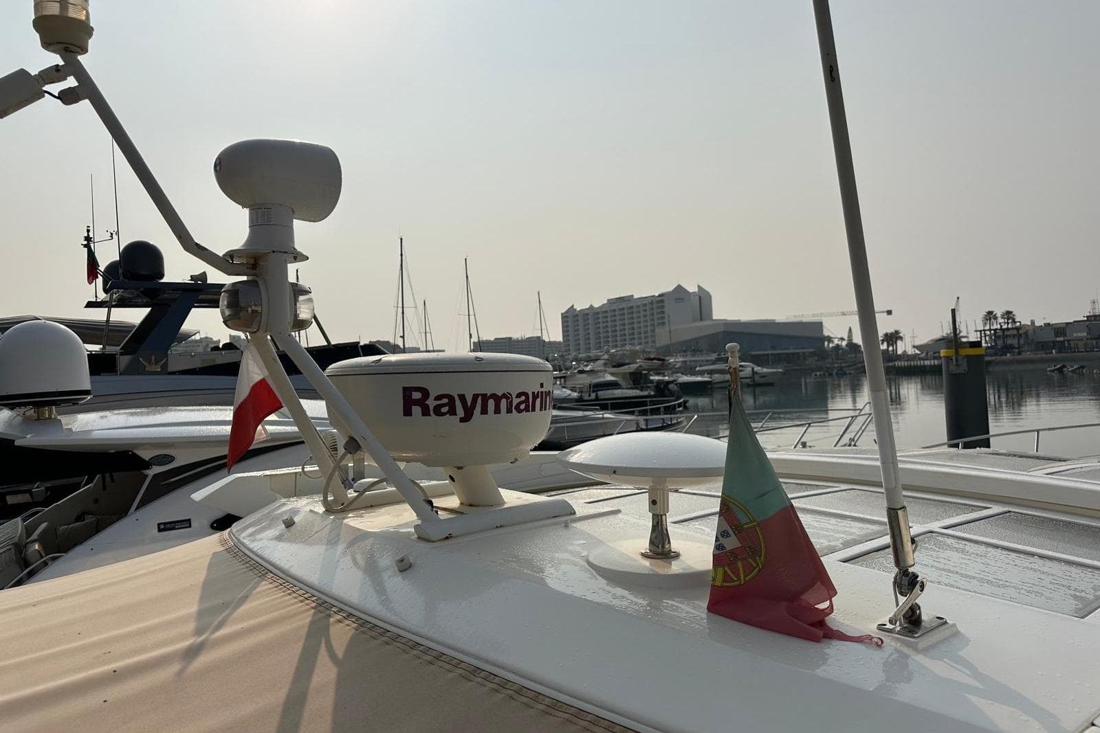 Luxury yacht Absolute 56 (2007) with Raymarine equipment docked in marina.