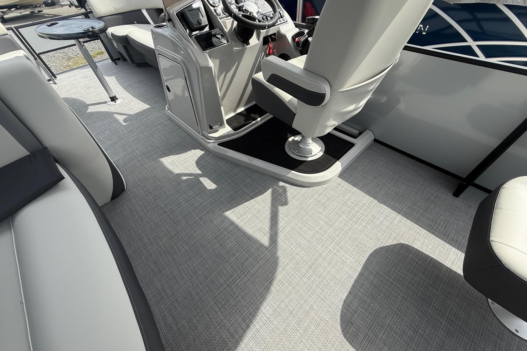 Interior of 2026 SLYVAN X-3 Party Fish boat with modern seating and control panel.