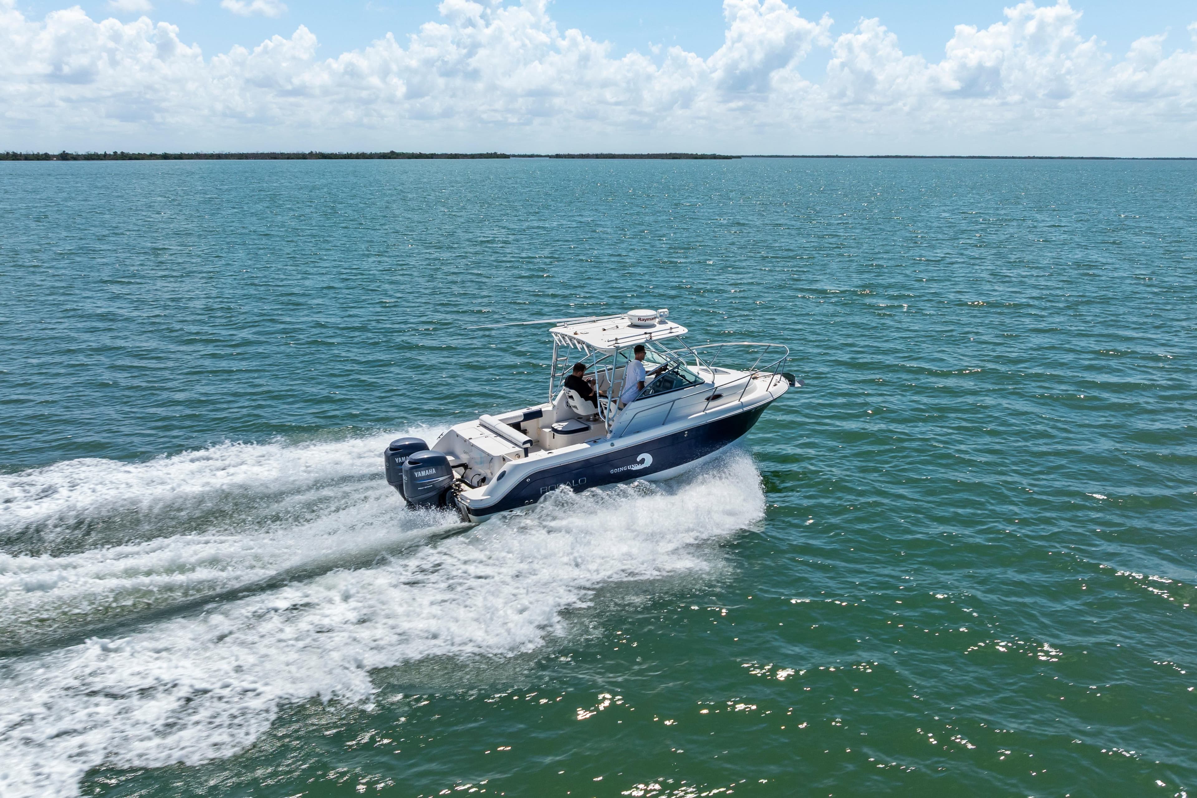2009 Robalo R245 Walkaround boat cruising on open water under a clear sky.