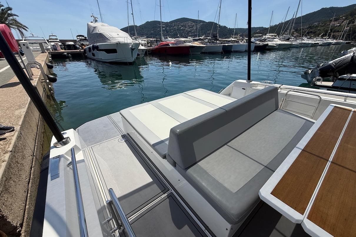 Luxury Windy SR44 SX yacht docked in marina, showcasing sleek seating and table design.