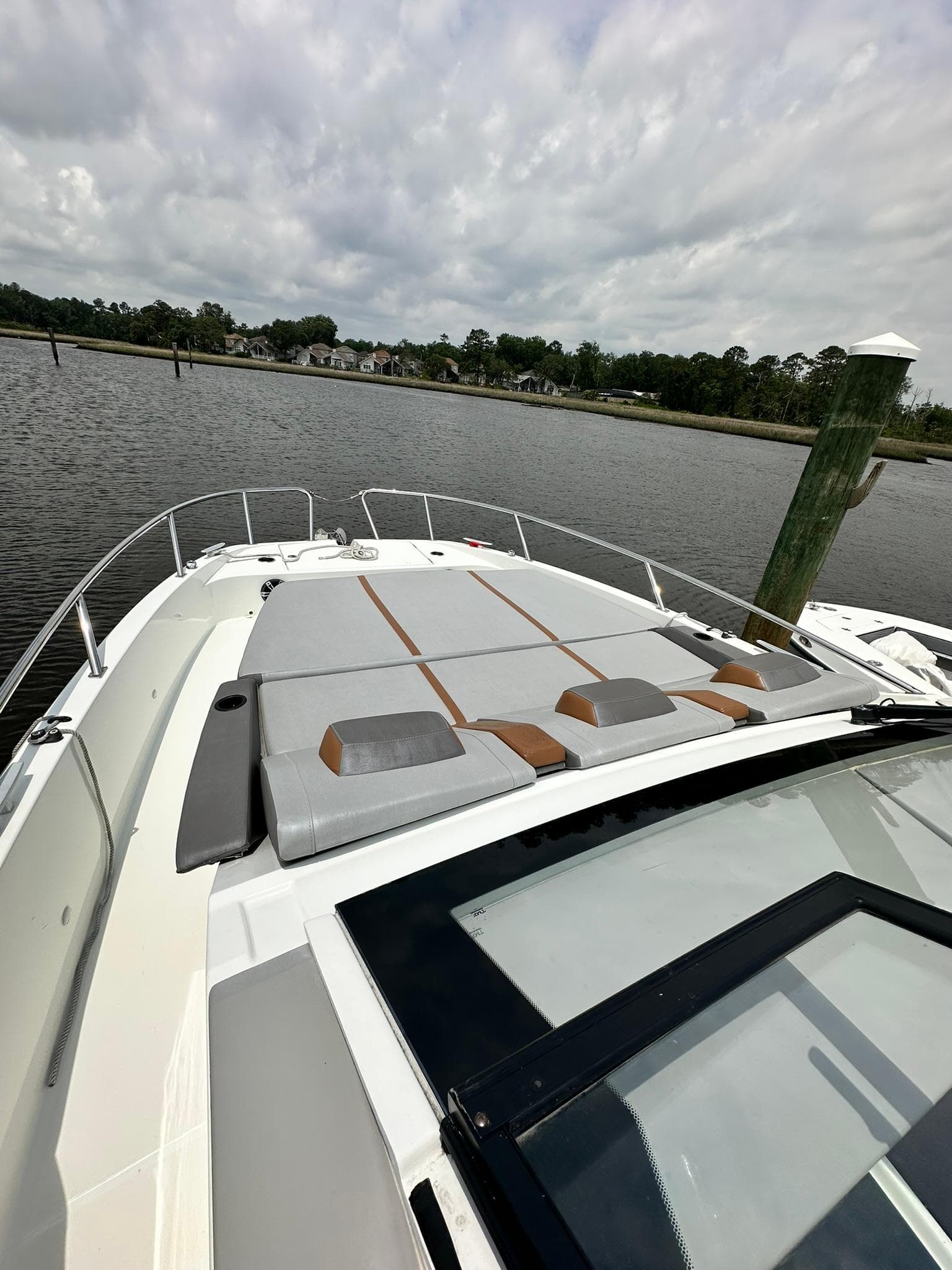 2021 Beneteau GT 32 boat with sleek deck design on a calm river.