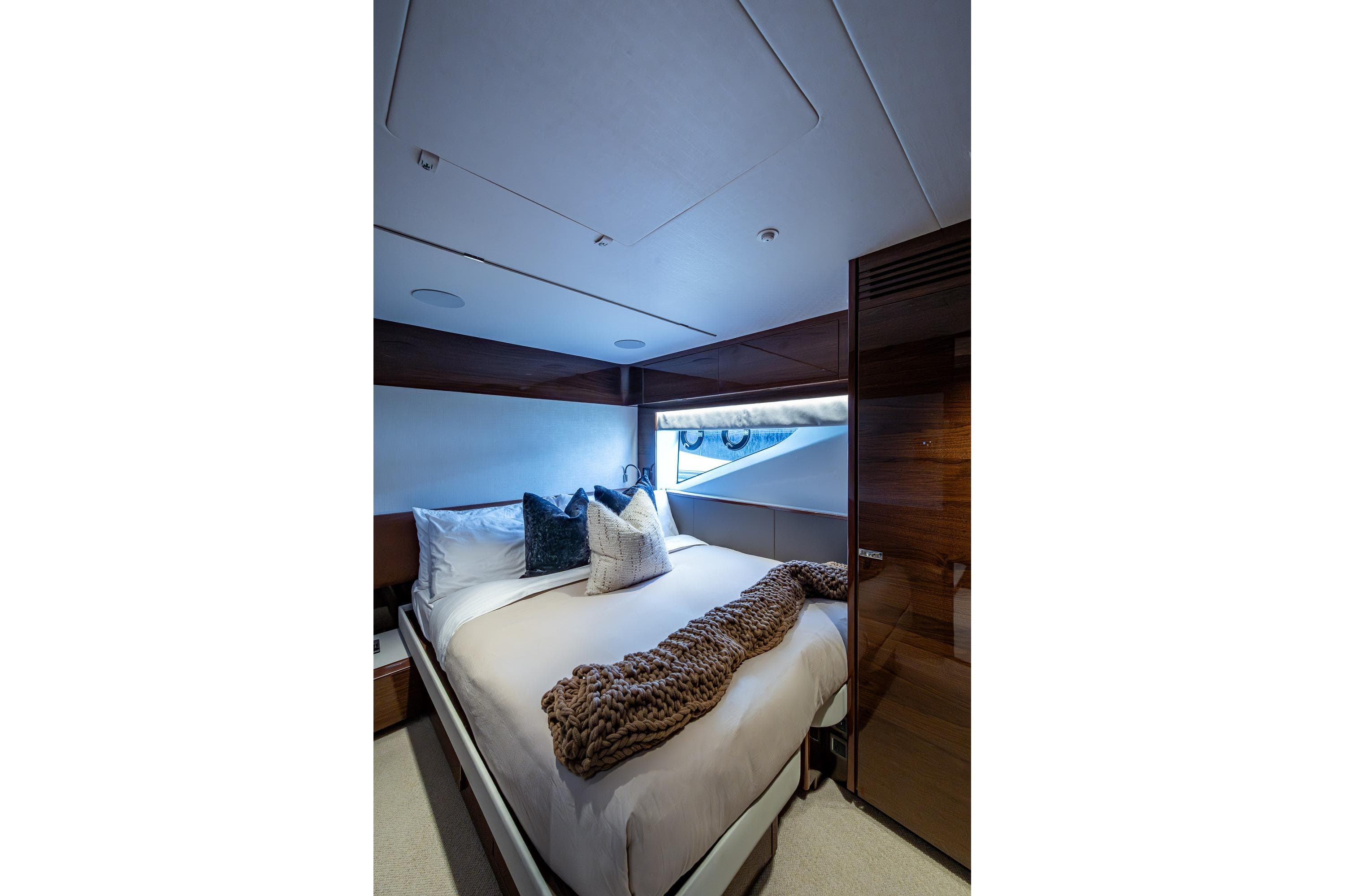 Luxurious bedroom interior of 2022 Princess X95 yacht with elegant bedding and modern design.