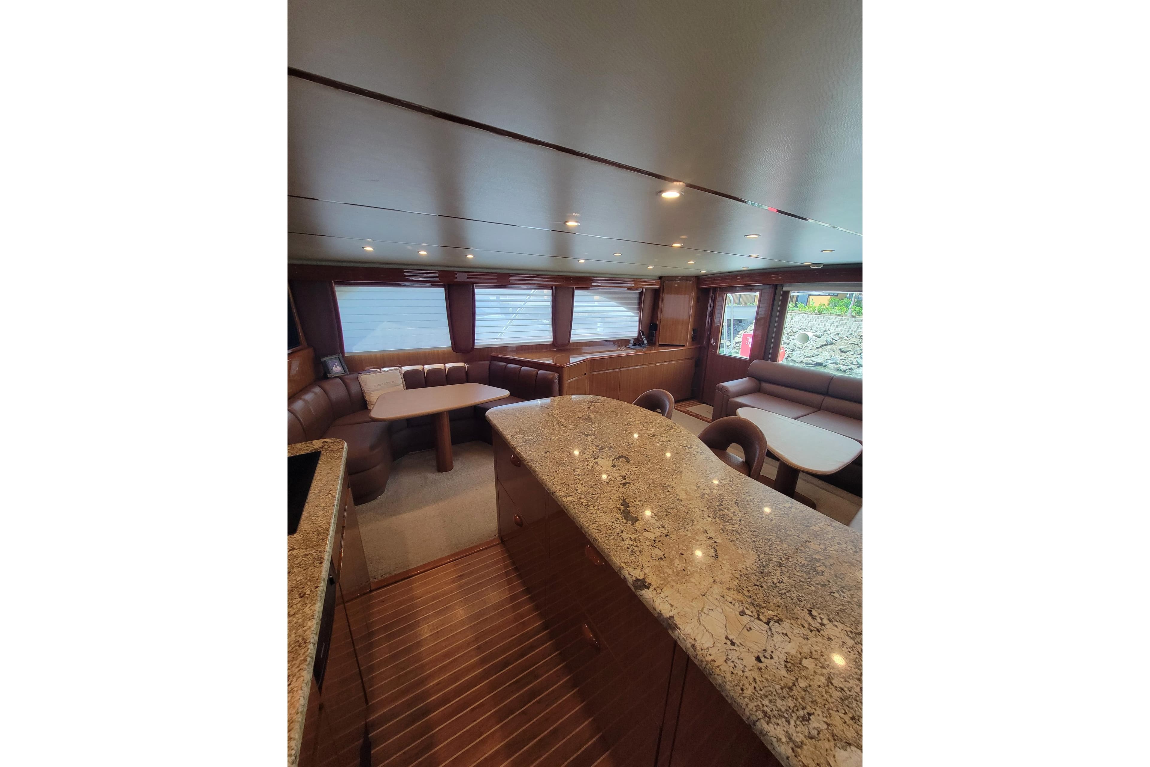 Luxurious interior of 2012 Viking 64c yacht with elegant seating and granite countertops.