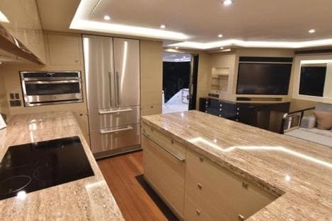 Luxurious kitchen interior on 2022 Horizon PC65 yacht with modern appliances and elegant lighting.