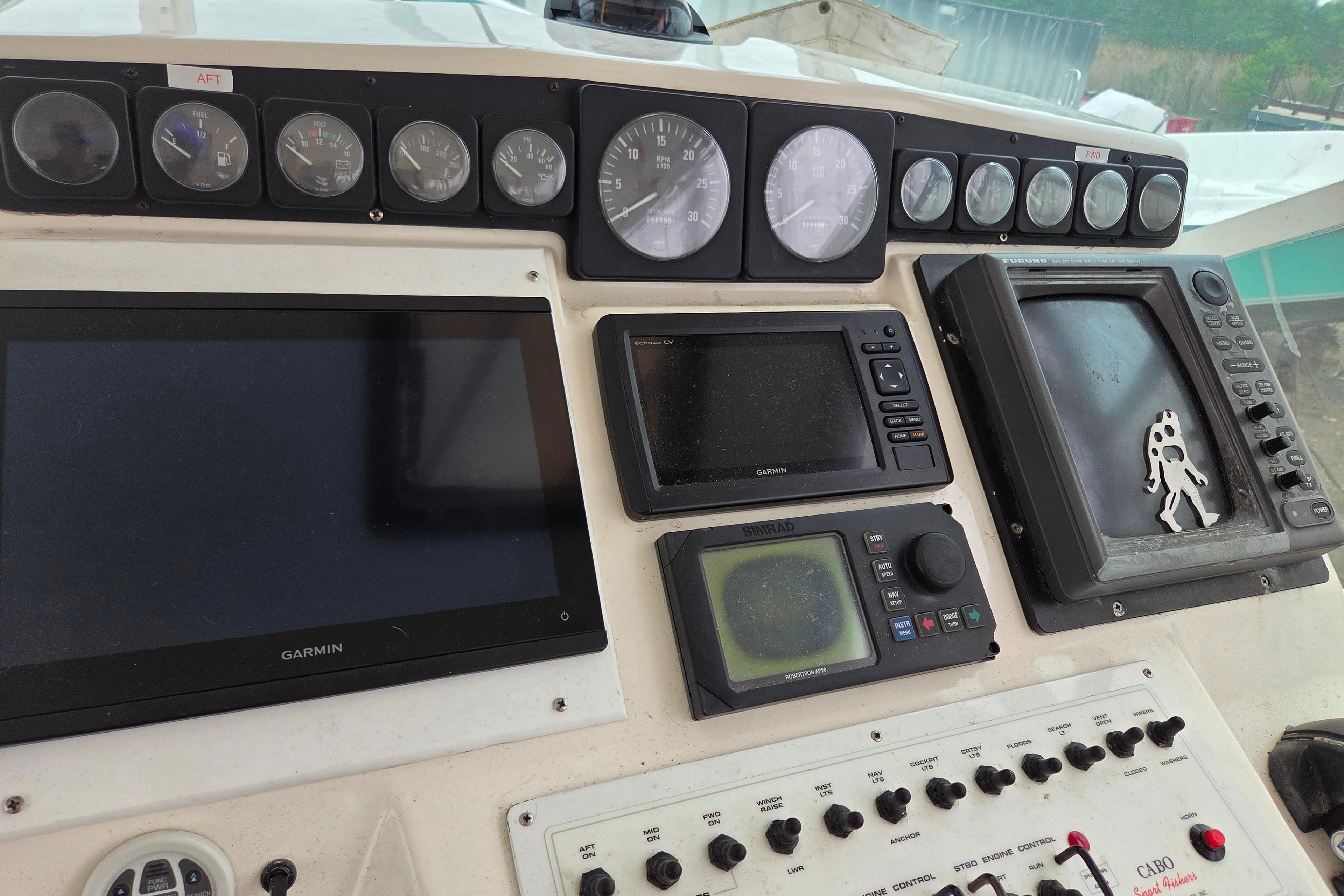 Control panel of a 1999 Cabo 35 Express boat with navigation instruments.
