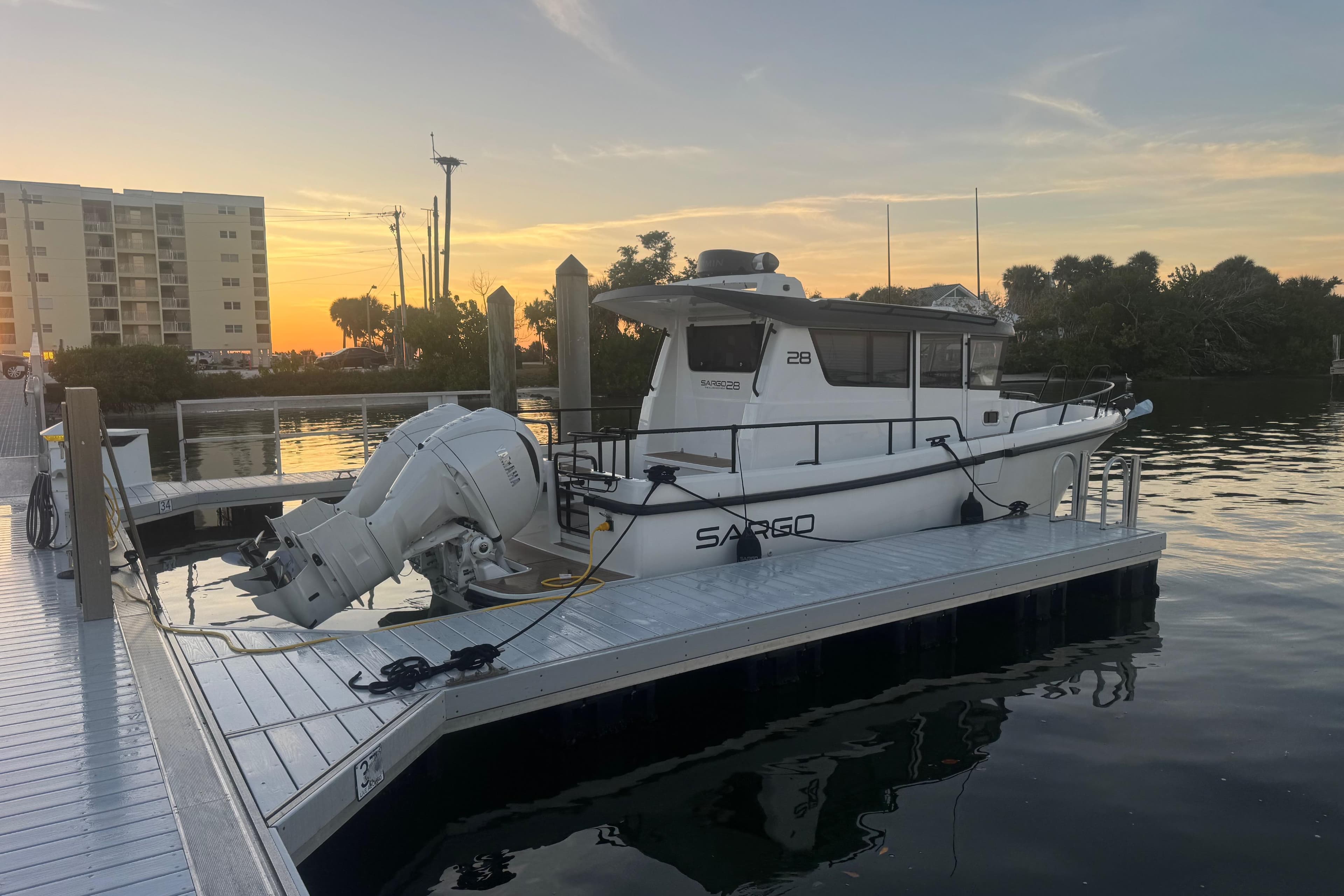 2025 Sargo 28 boat docked at sunset.