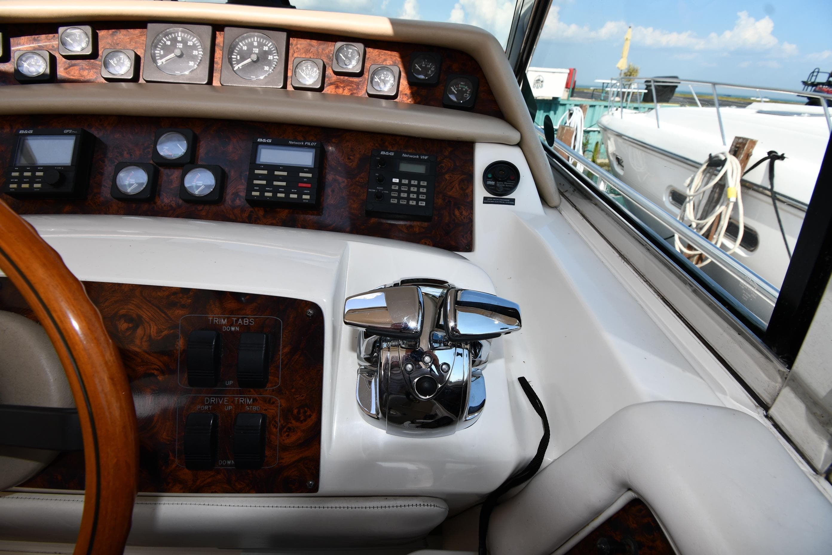 1995 Sea Ray 630 Sundancer helm with gauges, controls, and wood accents.