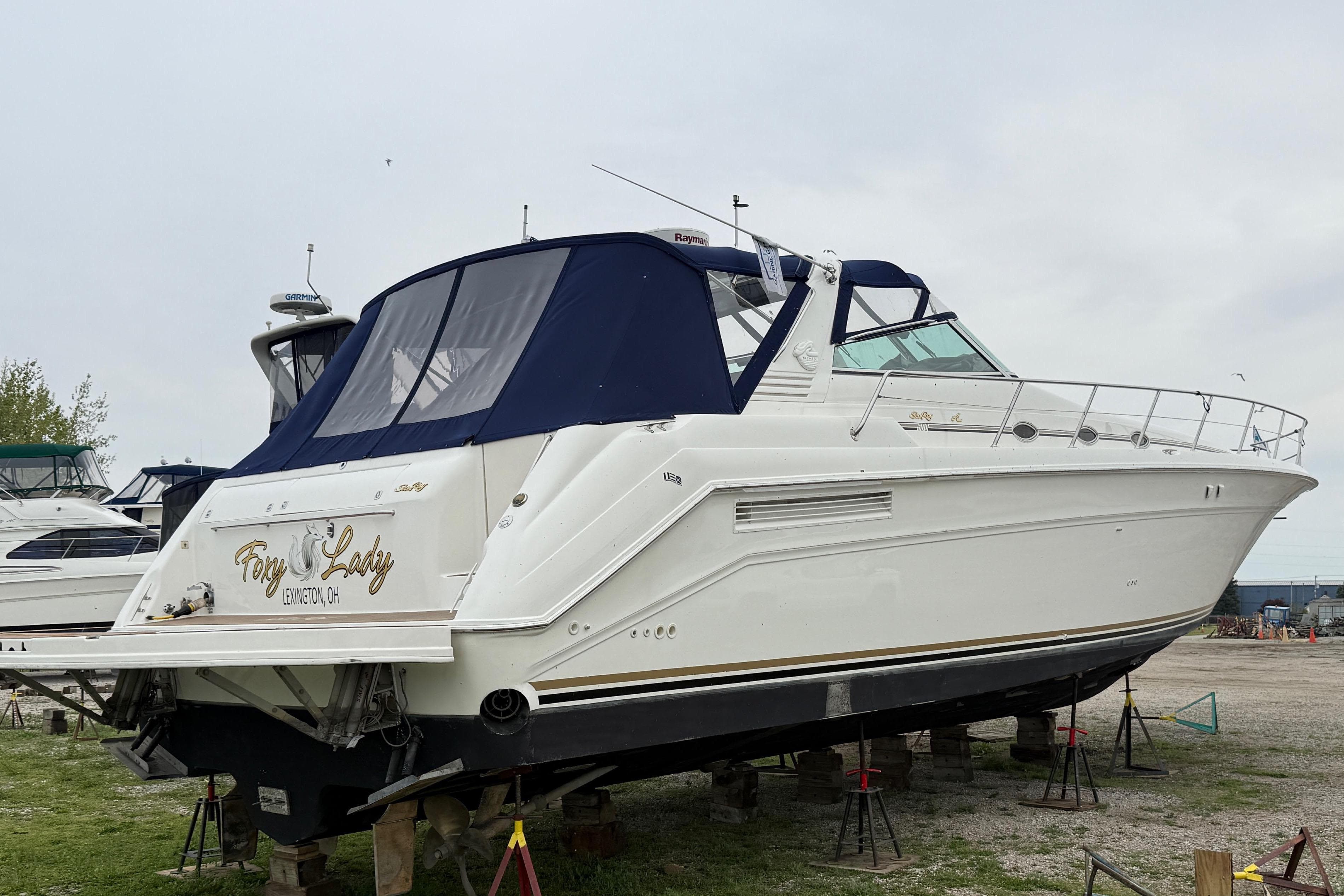 1998 Sea Ray 500 Sundancer yacht on stands outdoors.